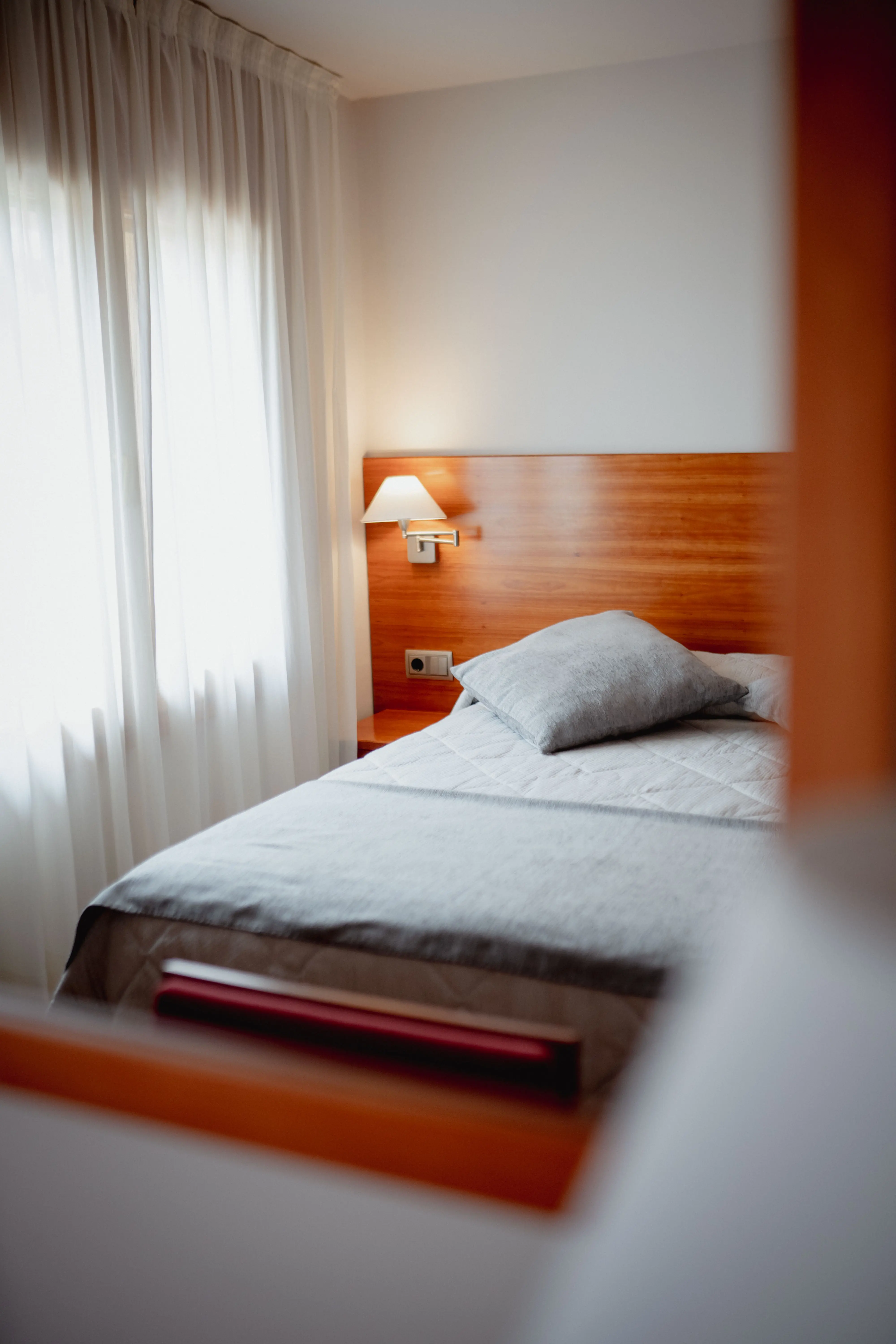 classy bedroom with white rooms, beige bed and blur grey duvet
