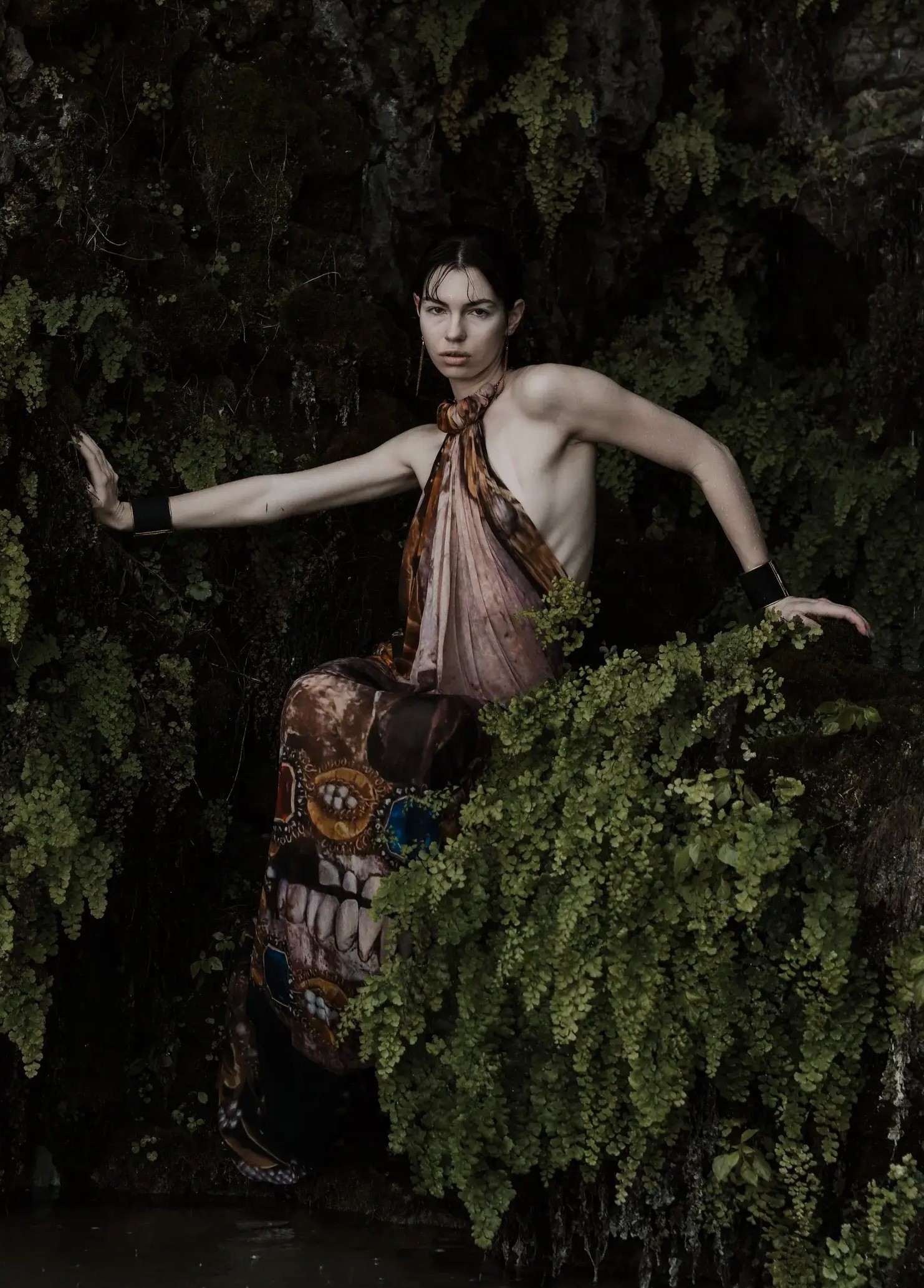 Editorial fashion portrait for Laura Homrich Photo featuring a model posed against lush dark greenery.