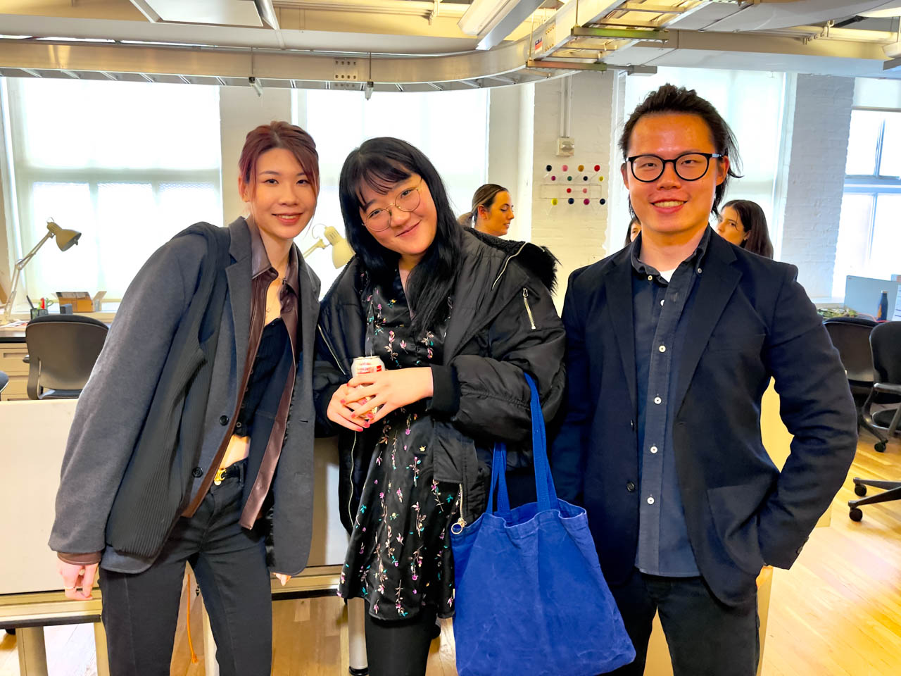 three students smiling for the camera