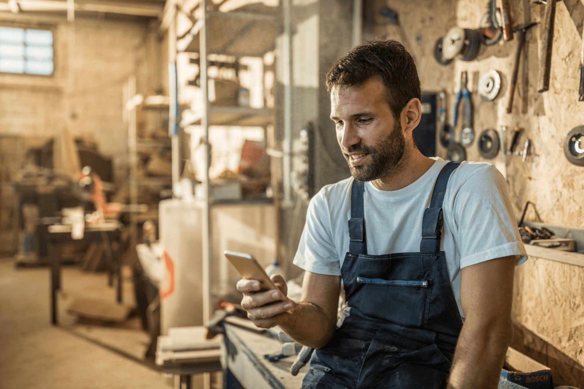 Tradesman filling out application on phone