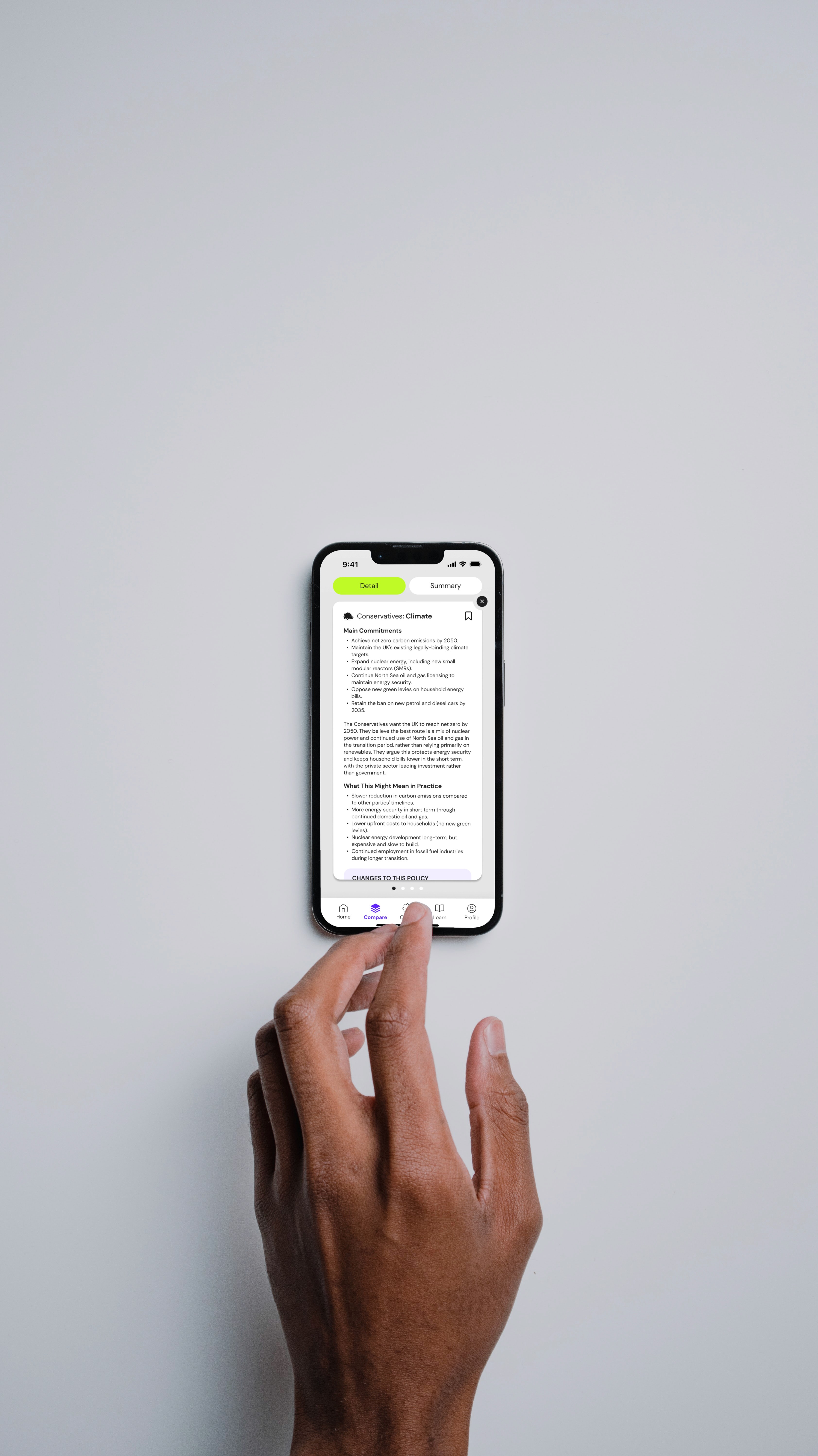 Man's hand scrolling through policy comparison screen.
