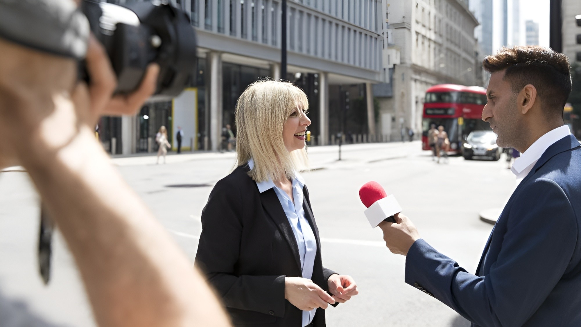 Reporter interviewing an executive on a city street