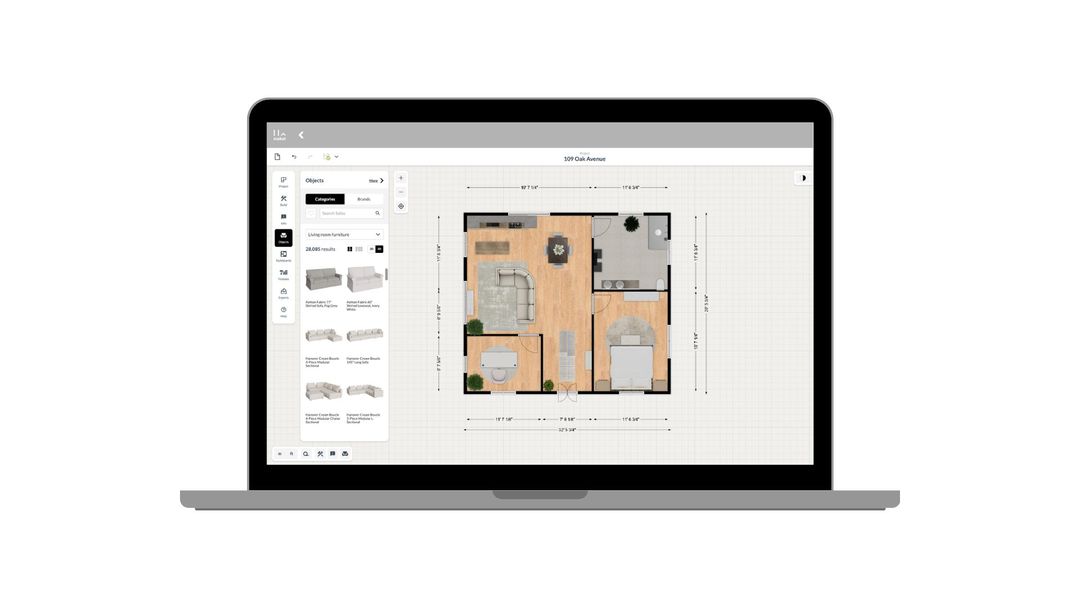 Laptop displaying floor plan design software with rooms and furniture layout on screen