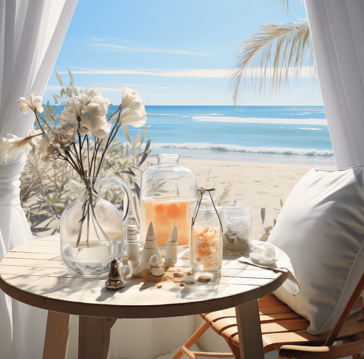 Beachside table with drinks, seashells, flowers, and ocean view.