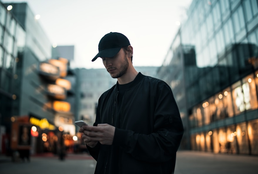 a person in black standing and looking downward