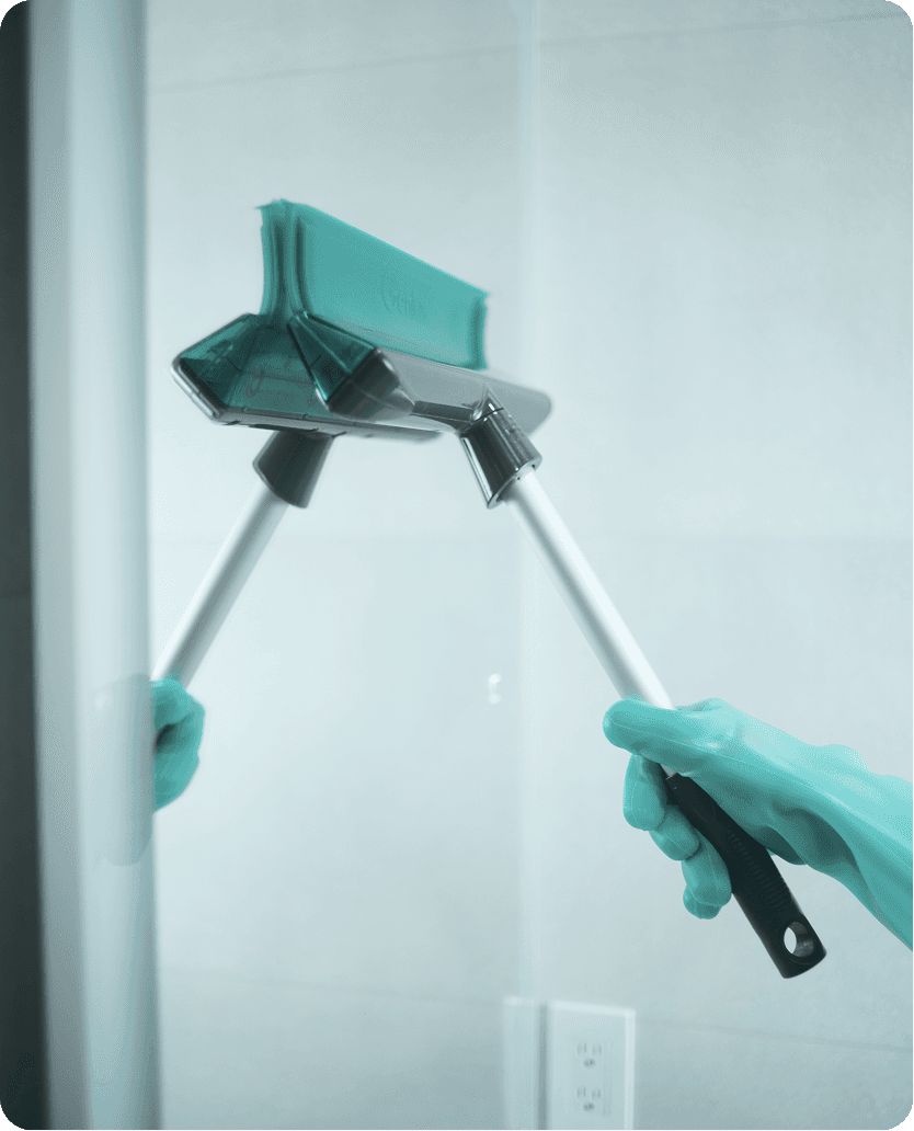 a cleaner clean the window with window cleaning brush.