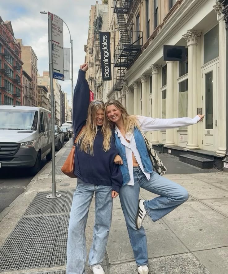 two people sitting at a table with laptops