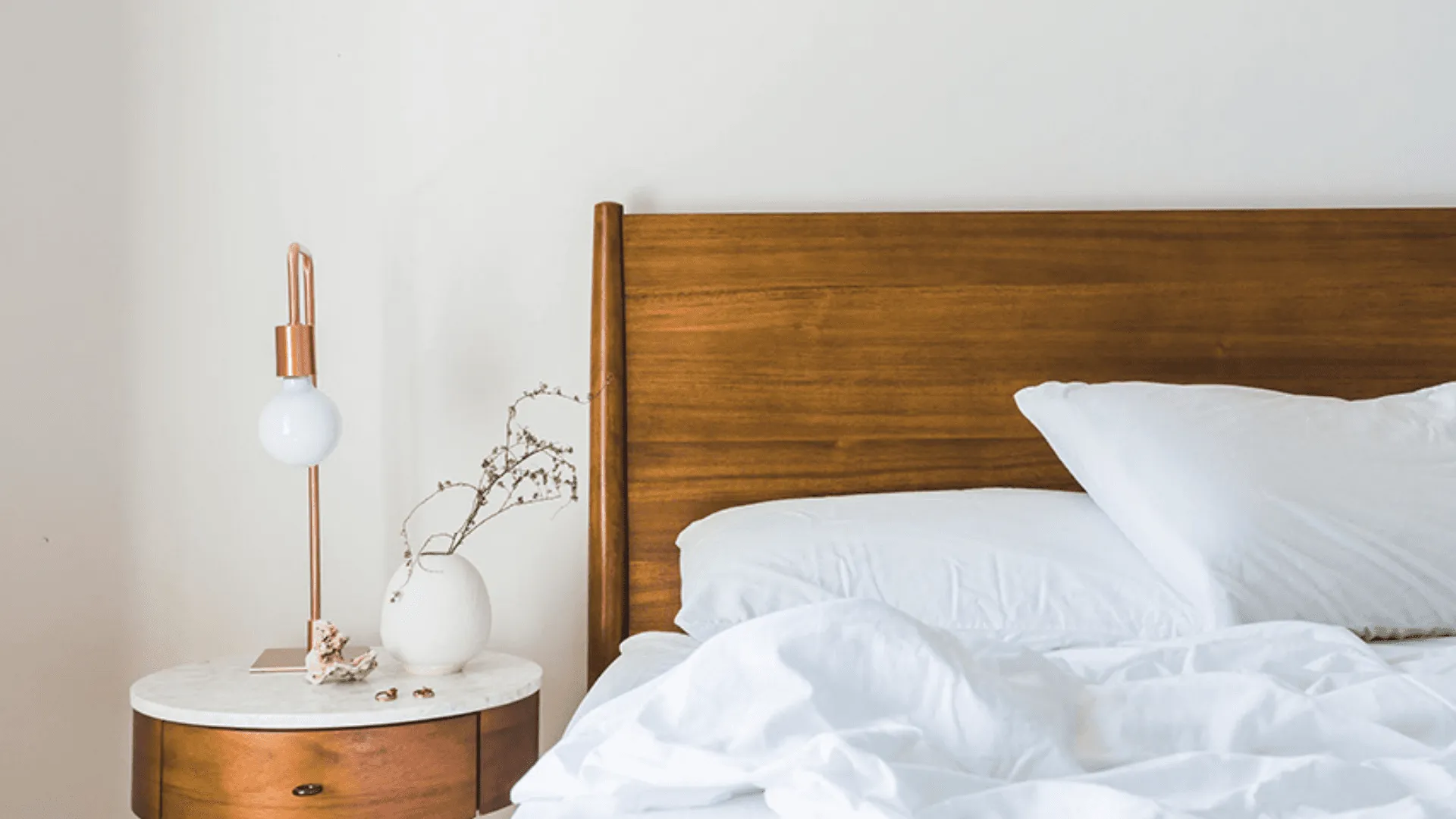 A shot of a comfortable looking bed with crisp white sheets