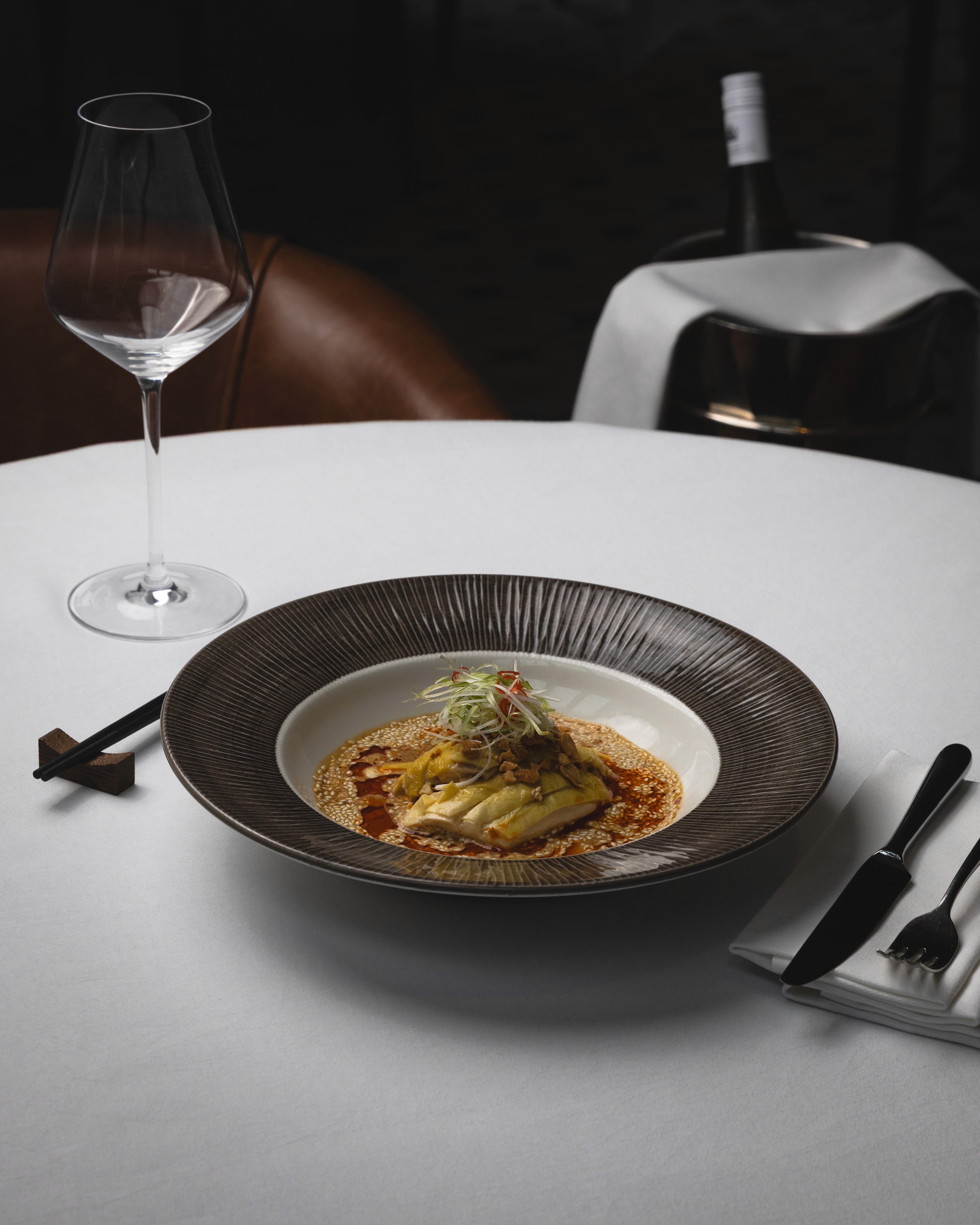 There are black and  white bottles sitting on top of a shelf