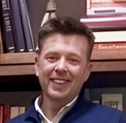 man in gray suit standing on gray concrete floor during daytime