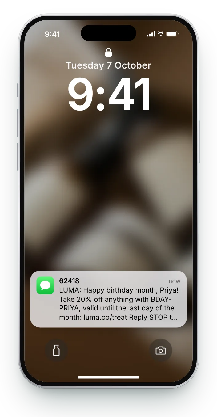 The birthday-month text as a notification on an iPhone lock screen