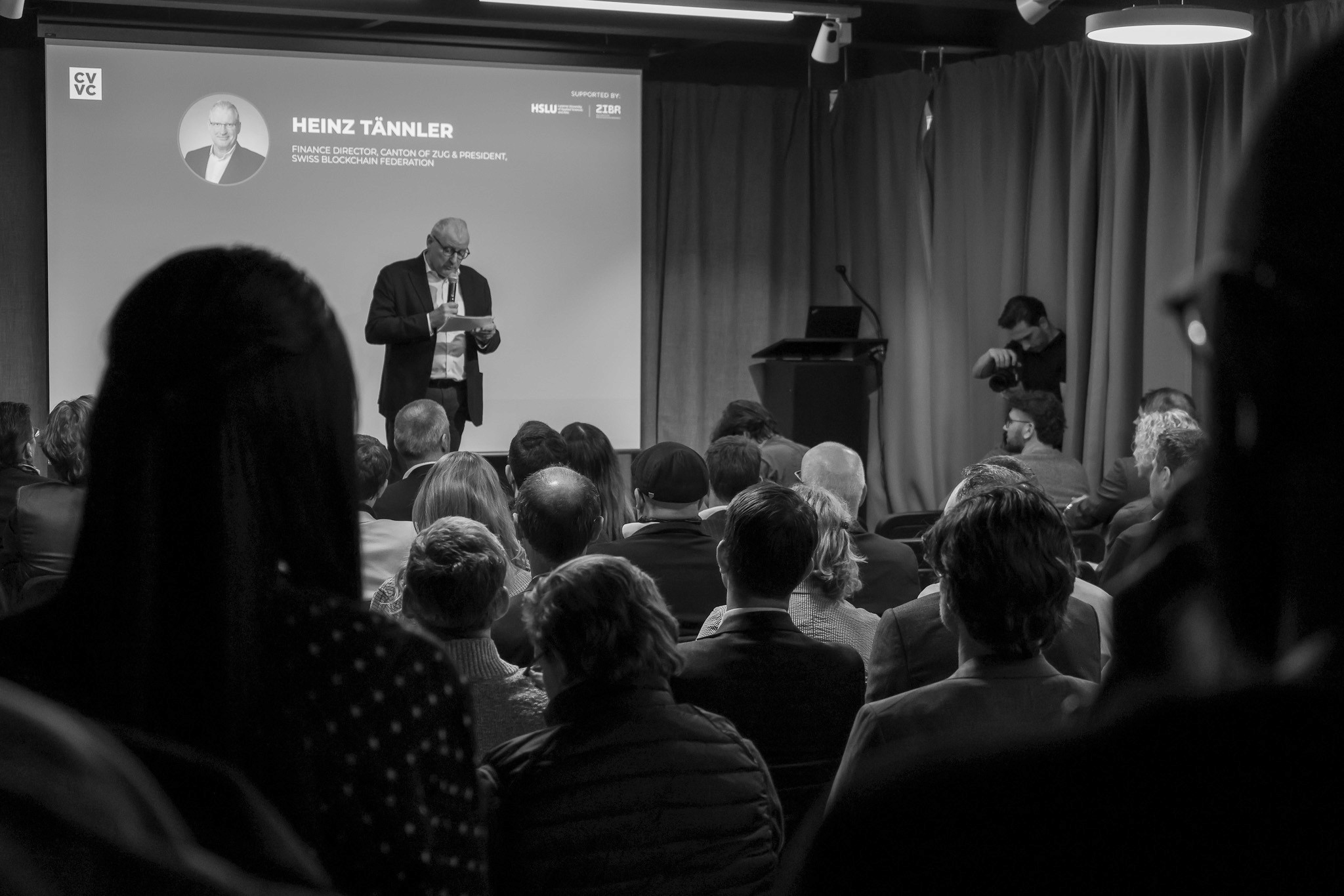 Audience attending a blockchain conference keynote photographed by Mizuri