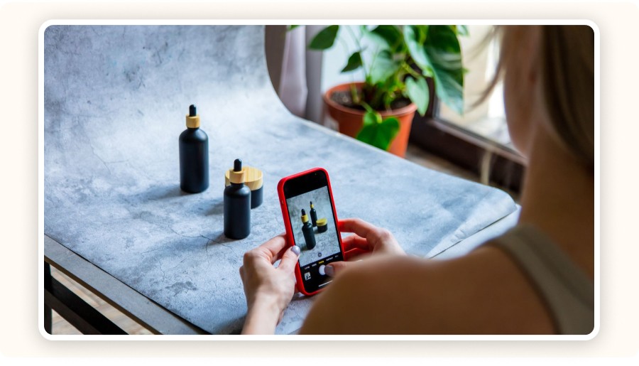 A person photographing bottles