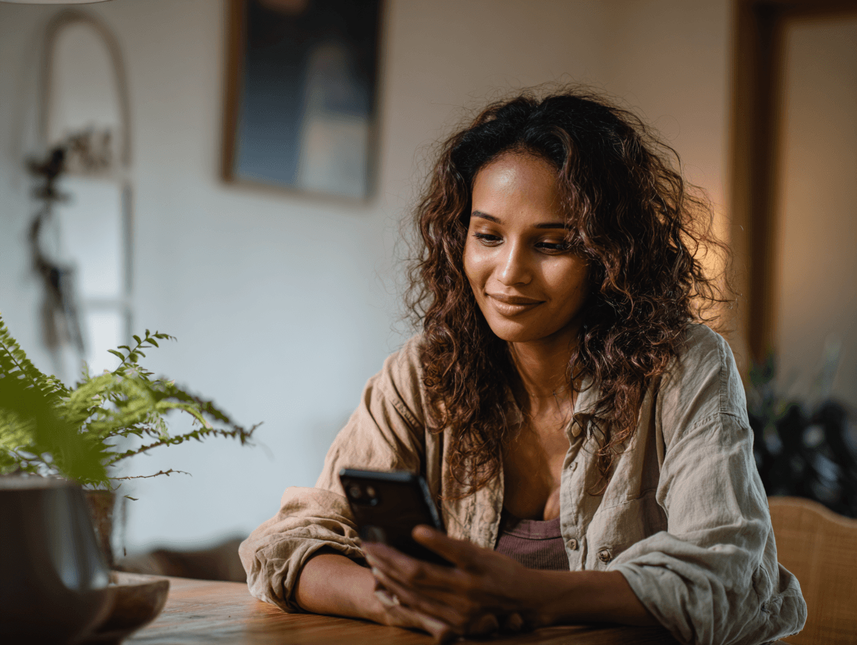 A maroon passport, a credit card, and a document are placed on a dark surface.