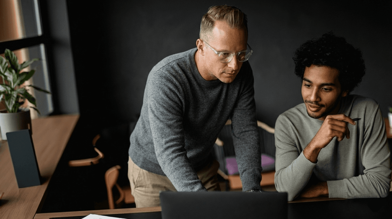 Two people working at a laptop