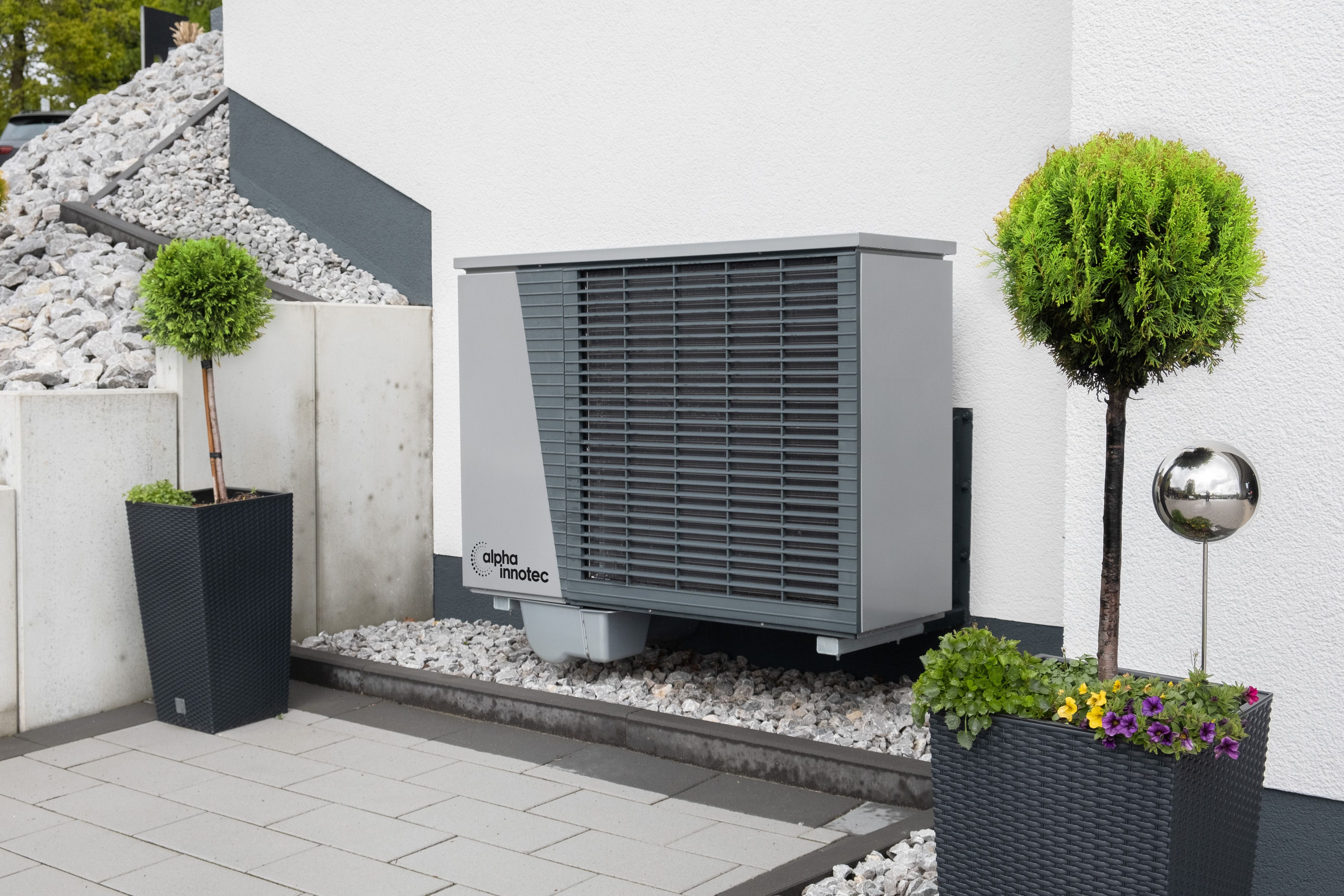 Four industrial air conditioning units lined up outside building