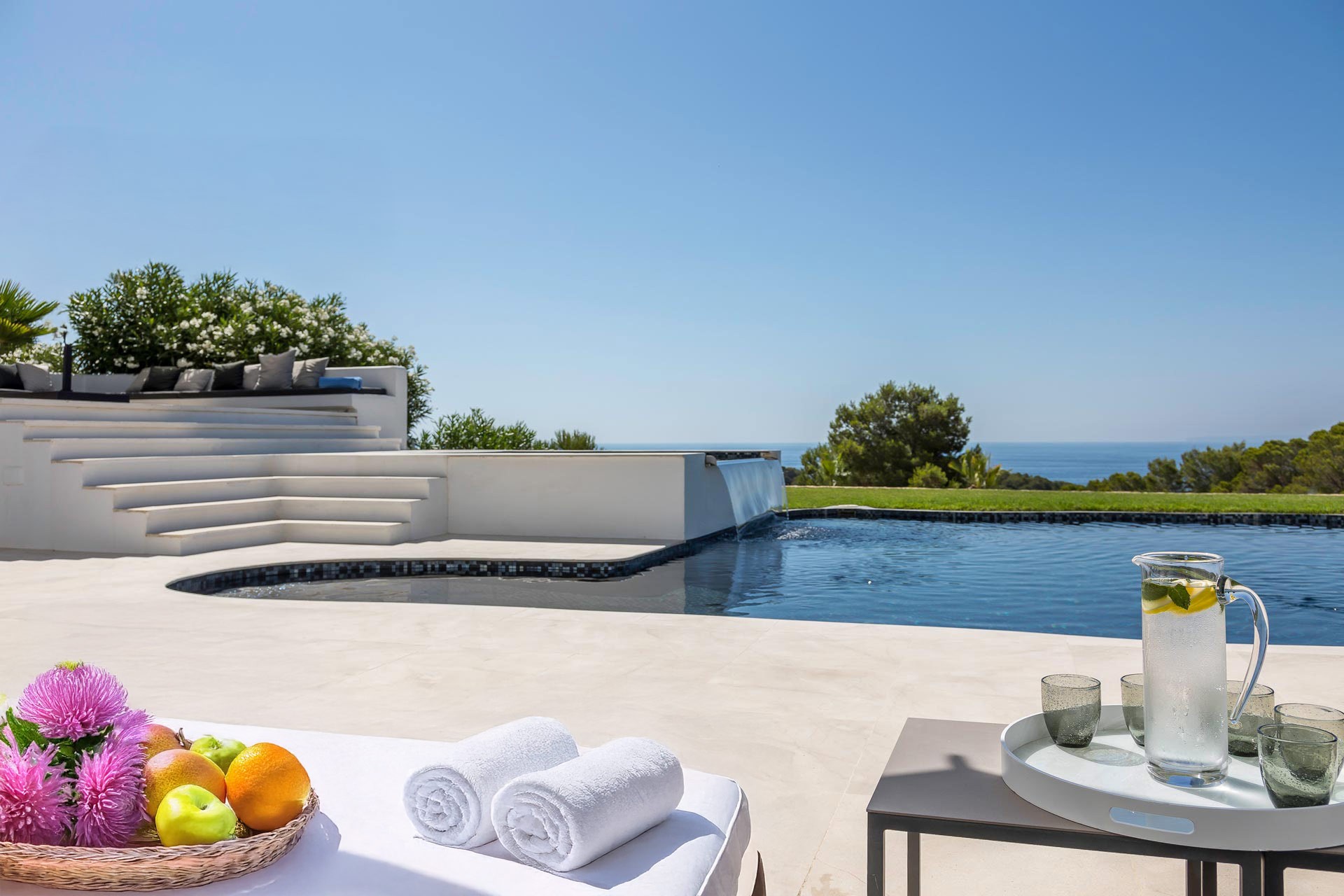 Pool terrace hospitality setup with refreshments, towels and luxury outdoor relaxation environment.