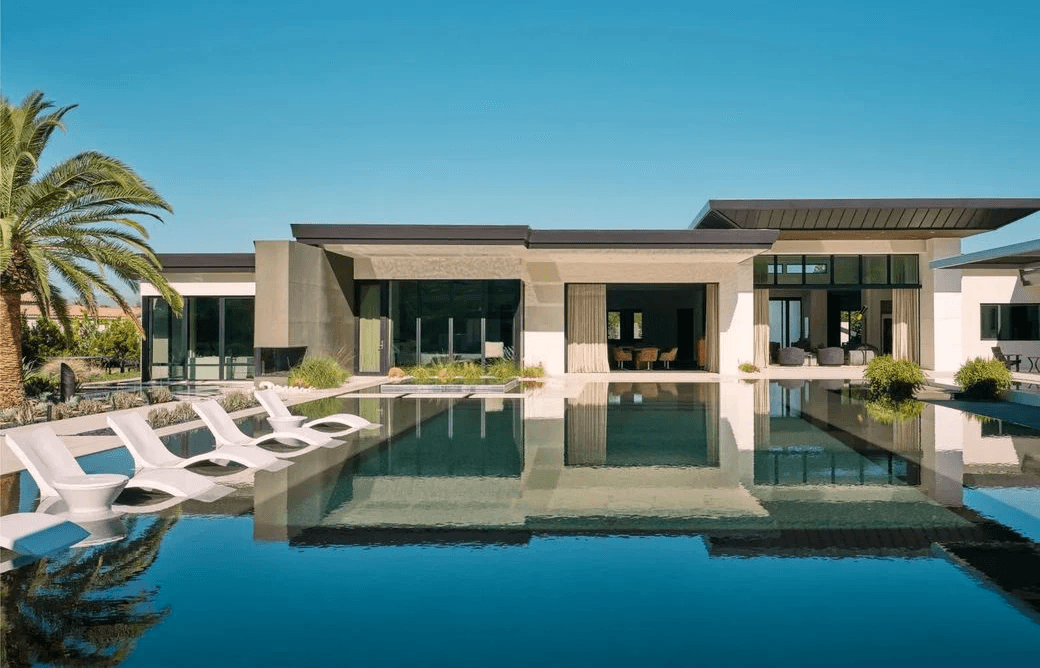 Modern single-level home and pool with palms, architectural reference photograph