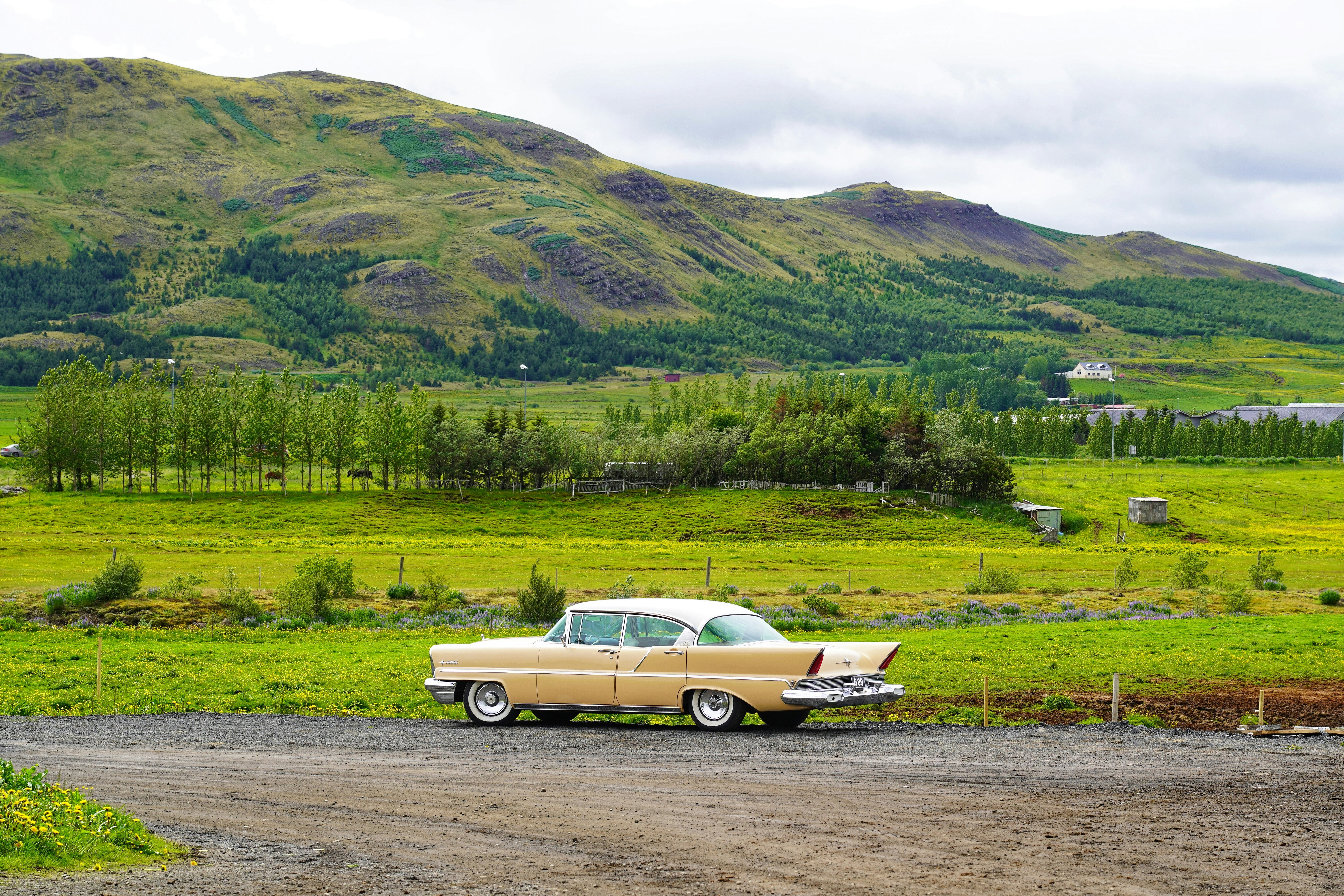 Vintage car parked along a road in Mosfellsdalur, Iceland.