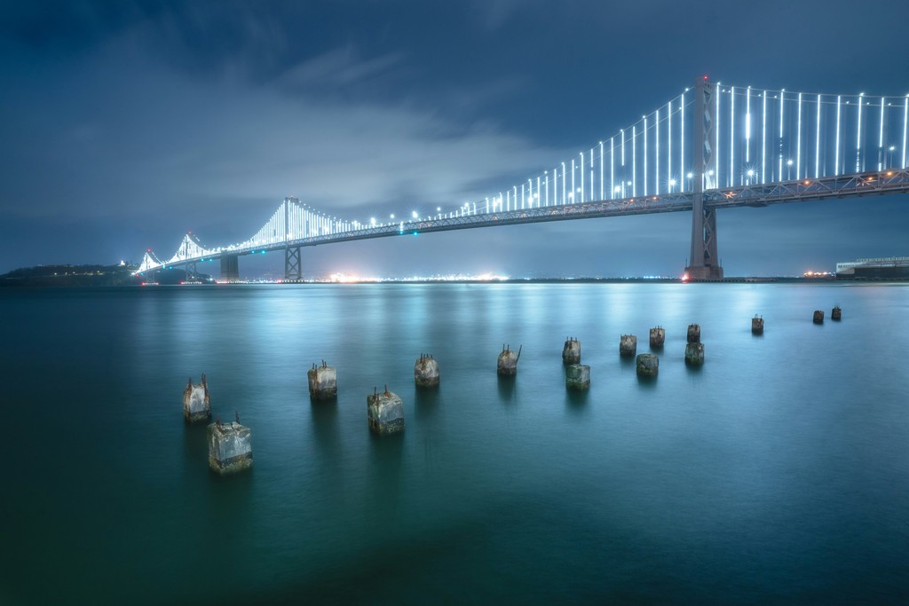 A bridge over water at night