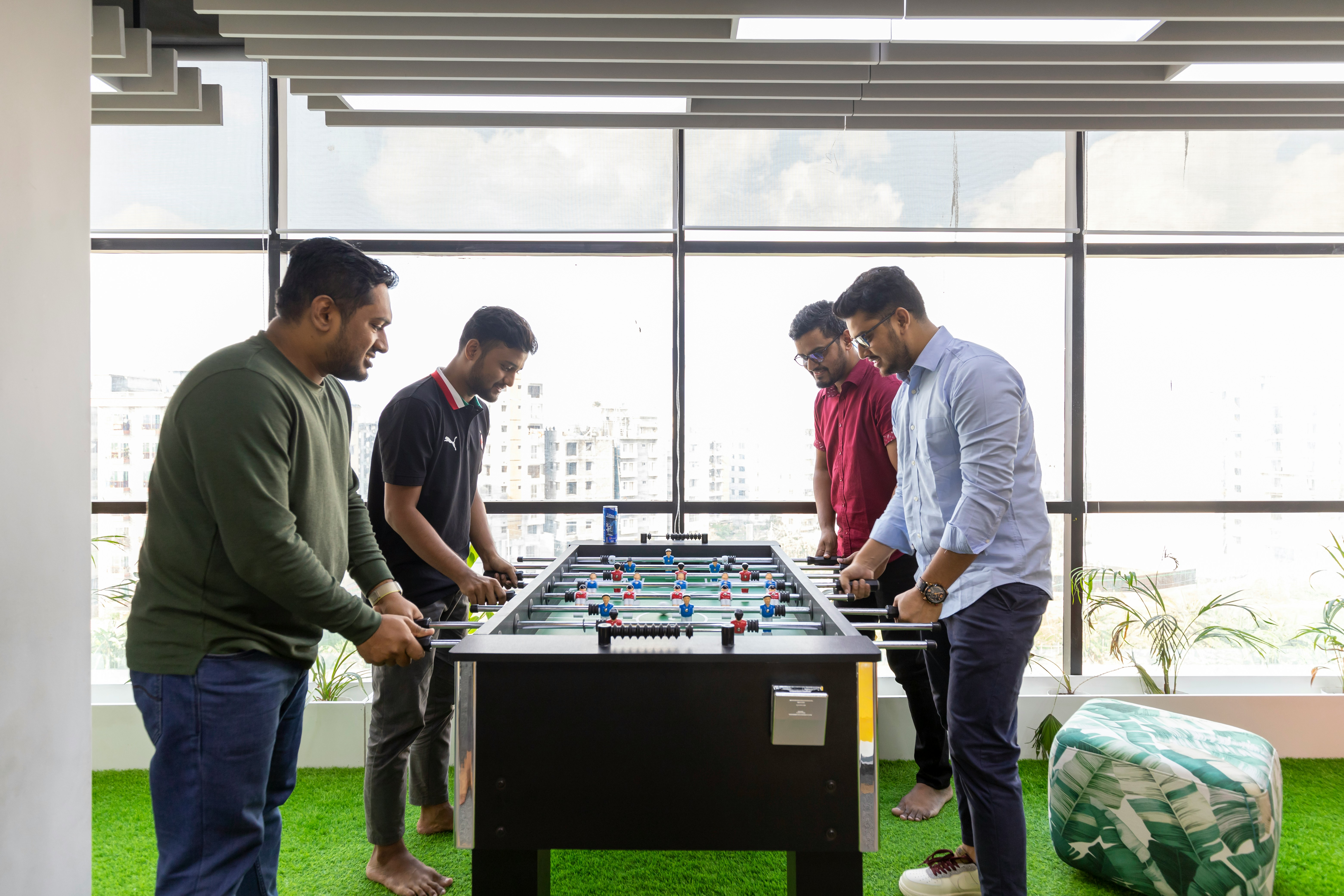 a group of men playing a game of foo - pong