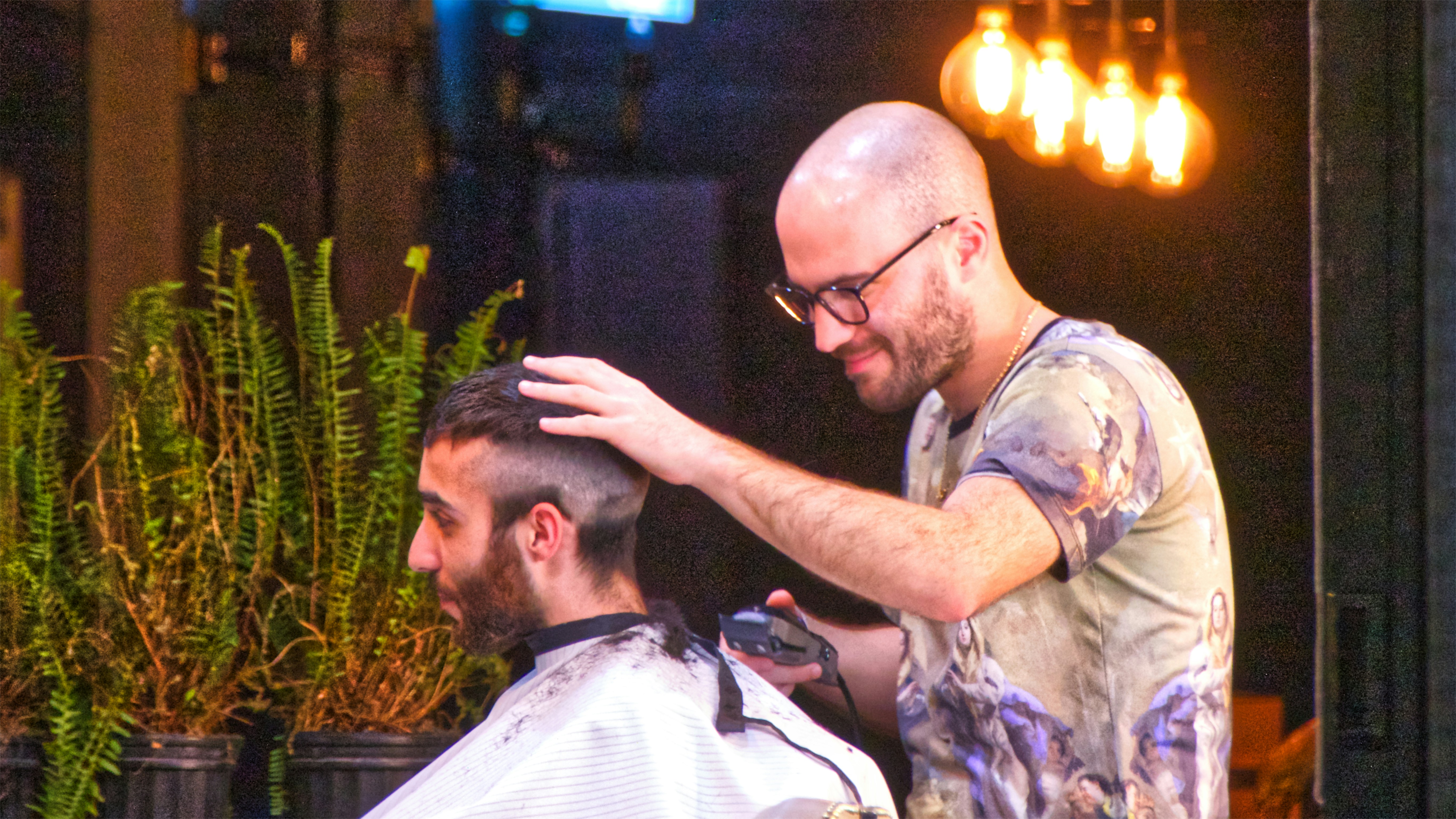 man shaving the hair of man