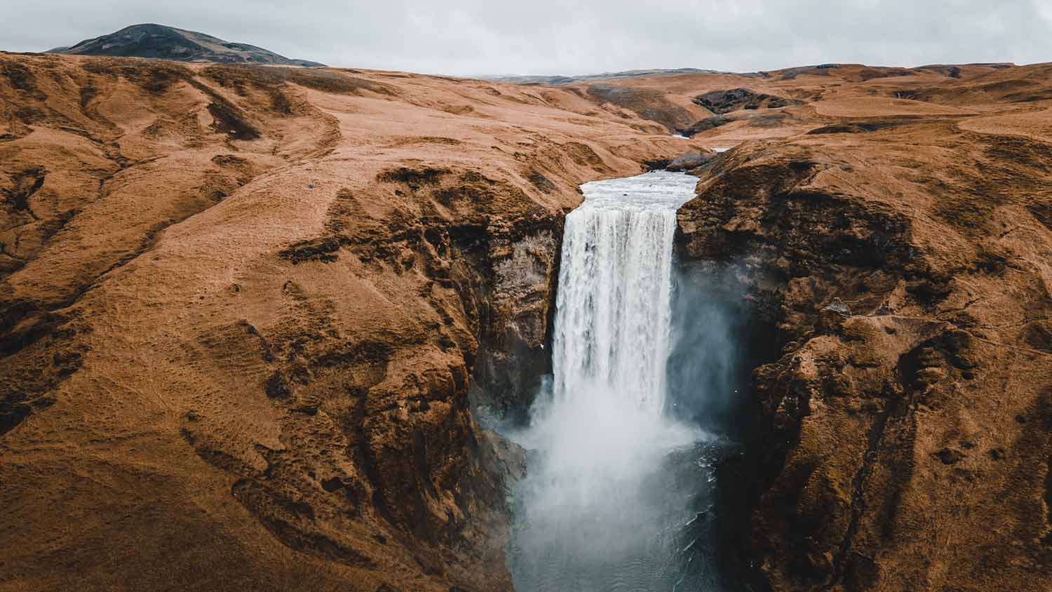 Majestic waterfall amid vast landscapes; perfect for filmproduction and ads.