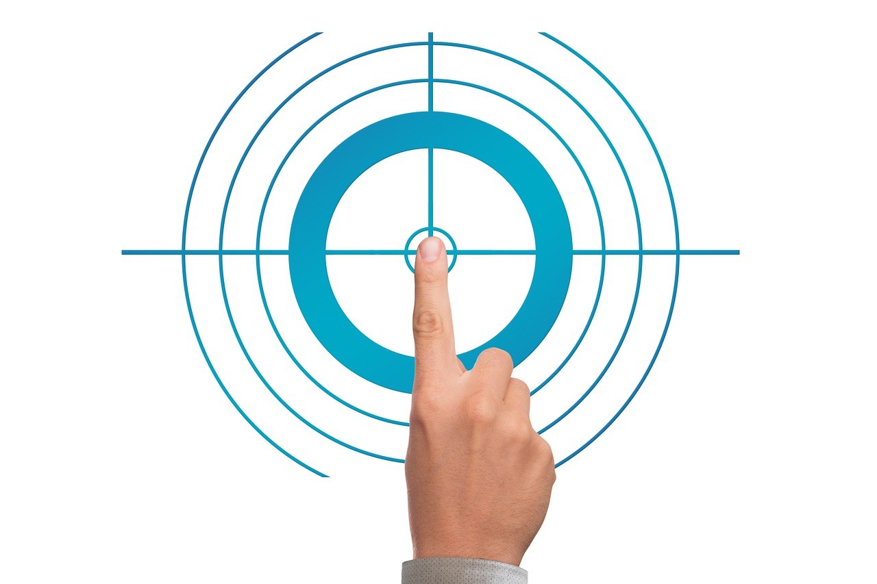 Finger pointing at target representing goal achievement
