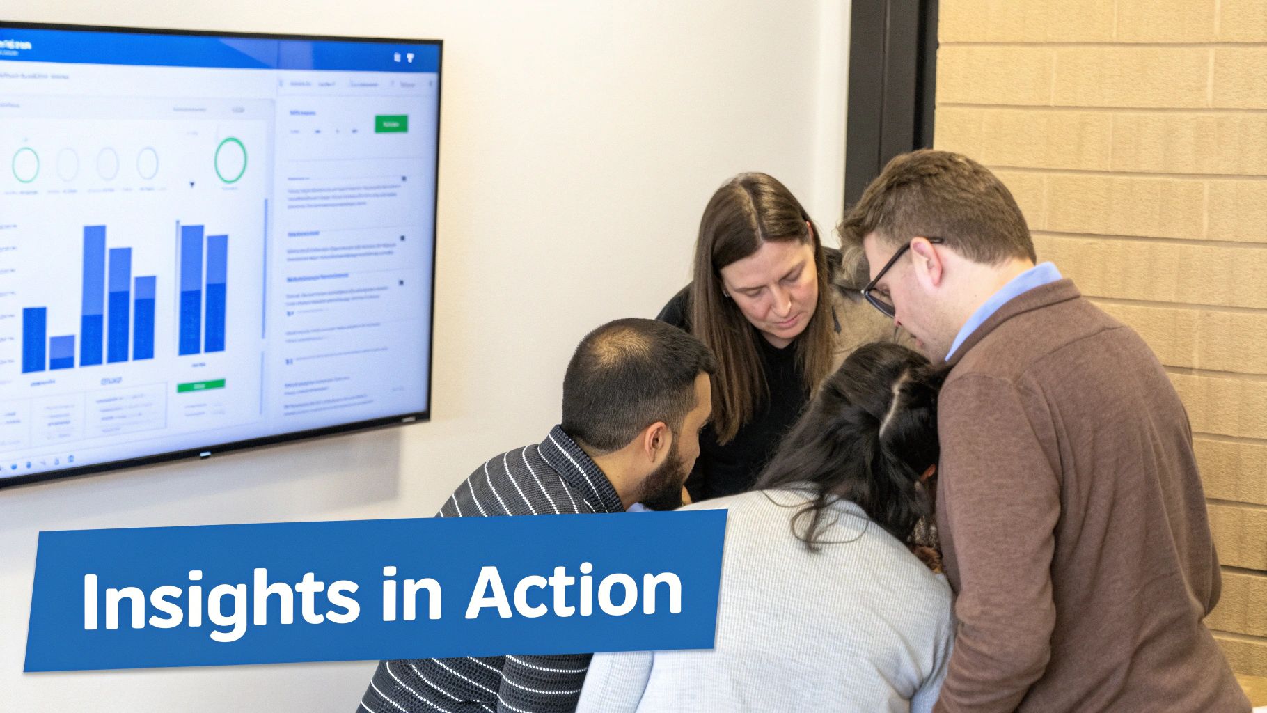 Four diverse people collaboratively examine a large screen displaying data analytics charts and insights.