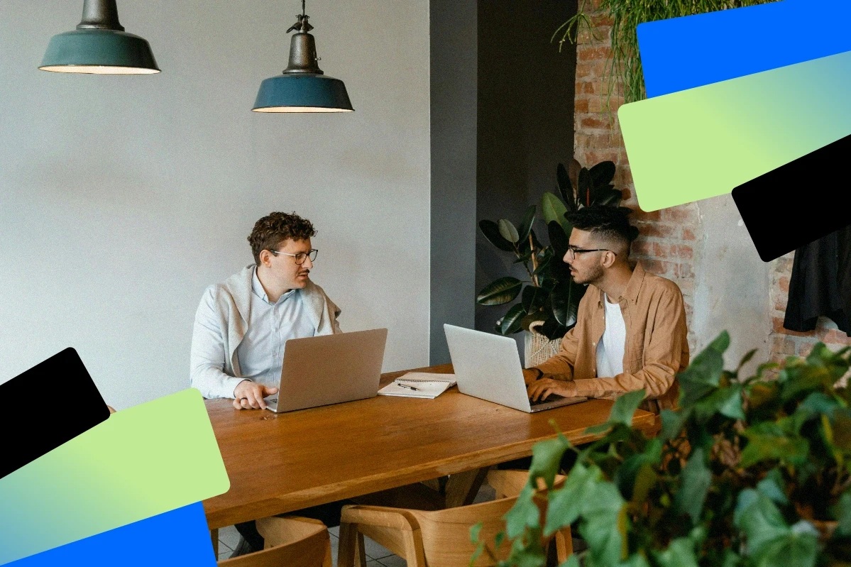Business owner reviewing funding options on a laptop with financial graphs on screen in a bright office
