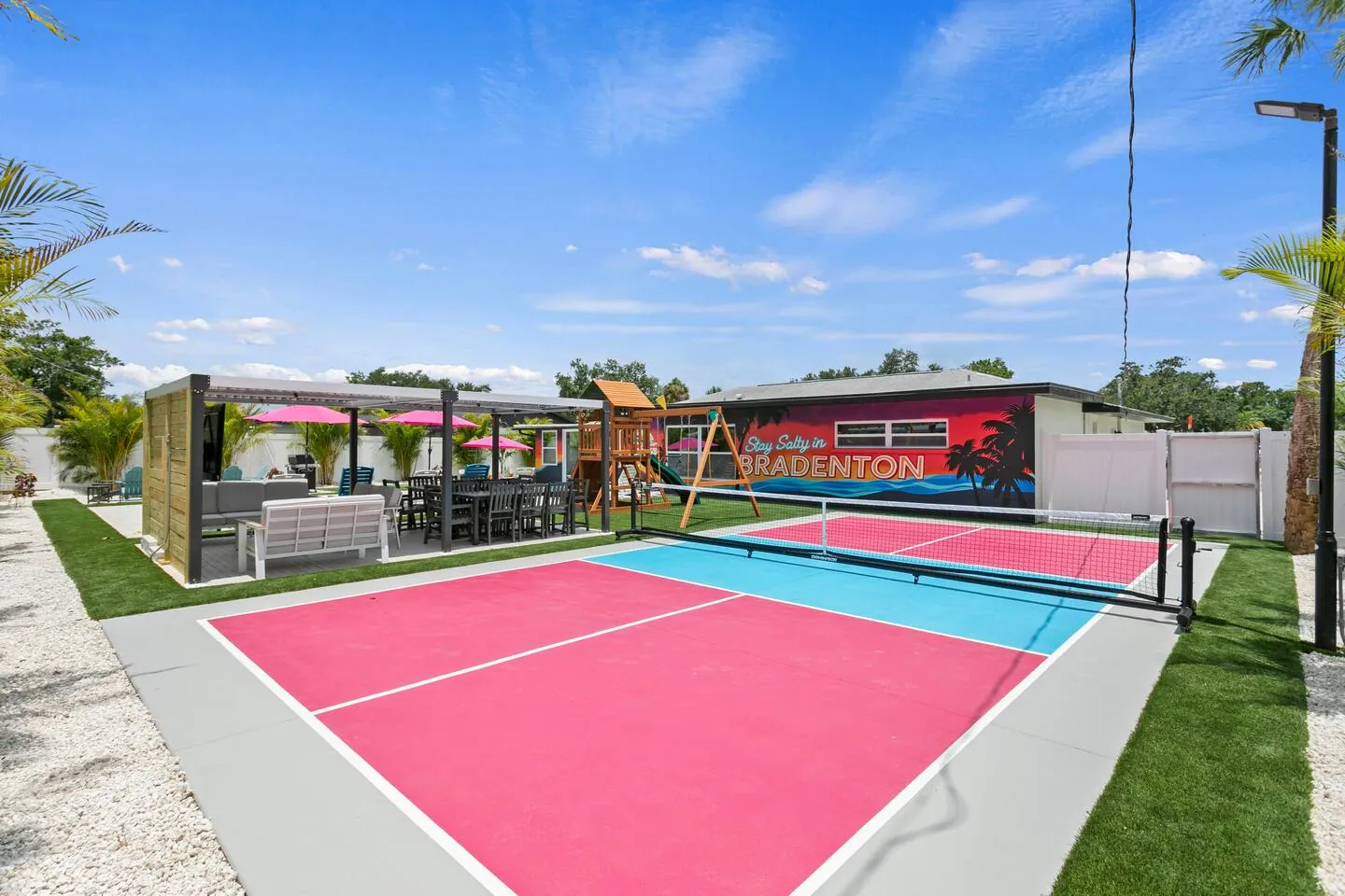 Pink-and-blue pickleball court at Salty House, Bradenton, Florida