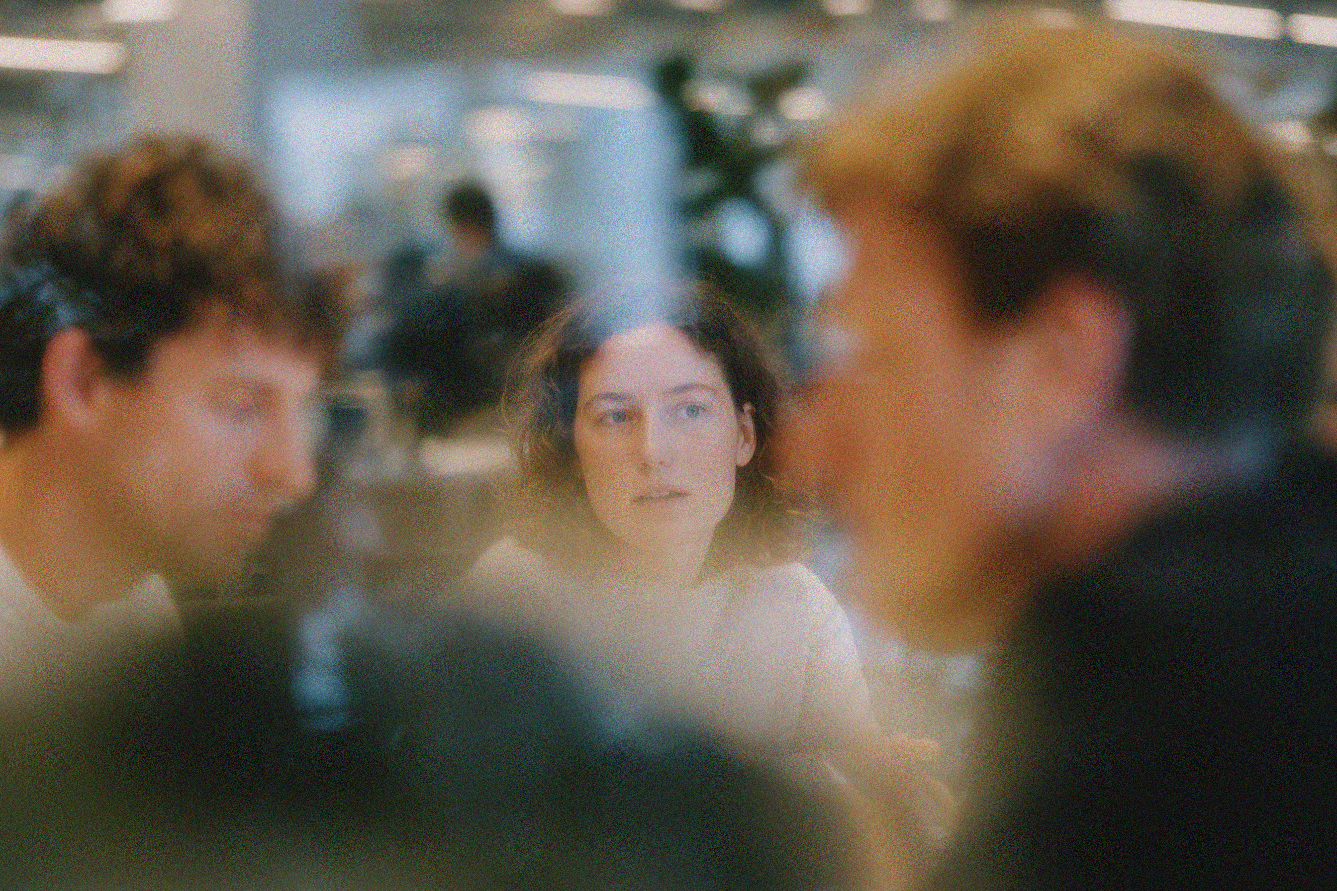  Collaborative work session overhead view of six people collaborating at a rustic wooden table with coffee, papers, and a laptop