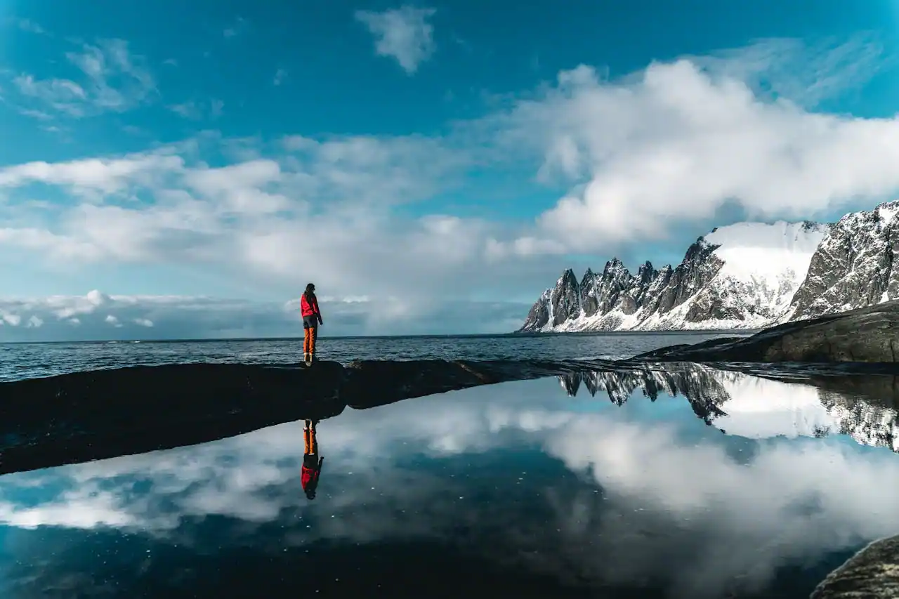 Couple posing for photographer with mountain backdrop
