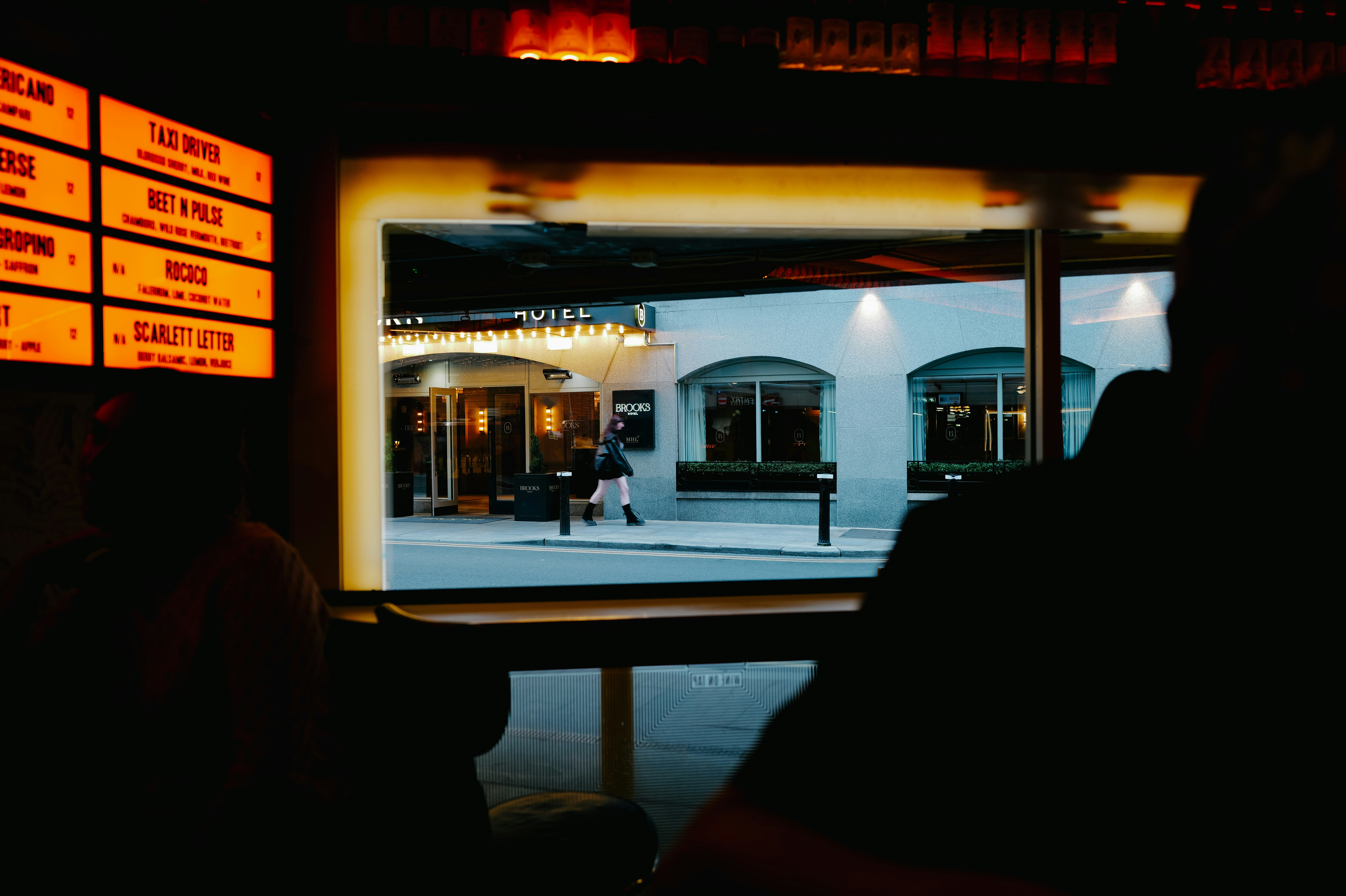 People silhouetted in foreground looking at building entrance.