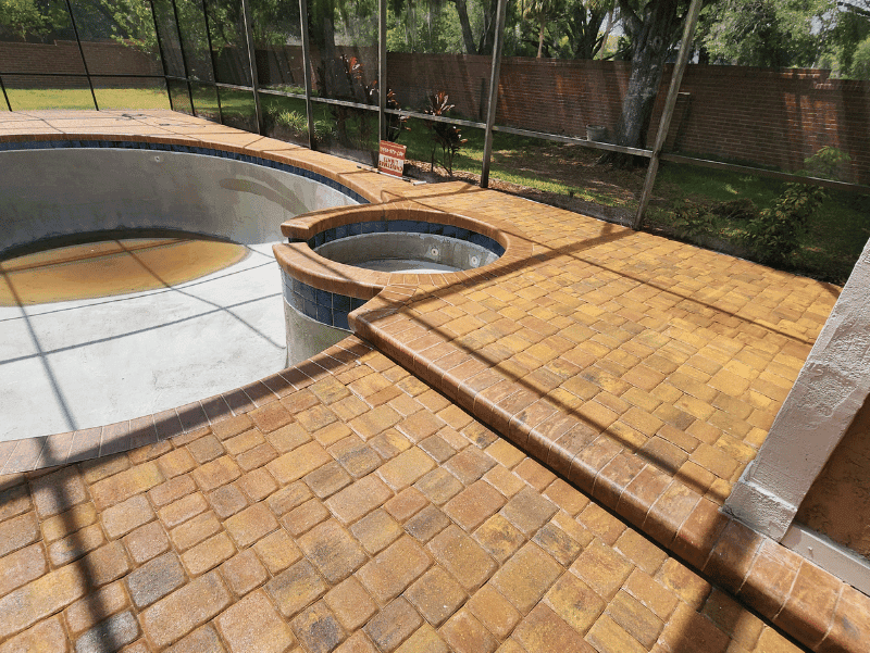 Pool deck in Oviedo, FL that had failed sealer removed from the pavers and then was re-sealed correctly