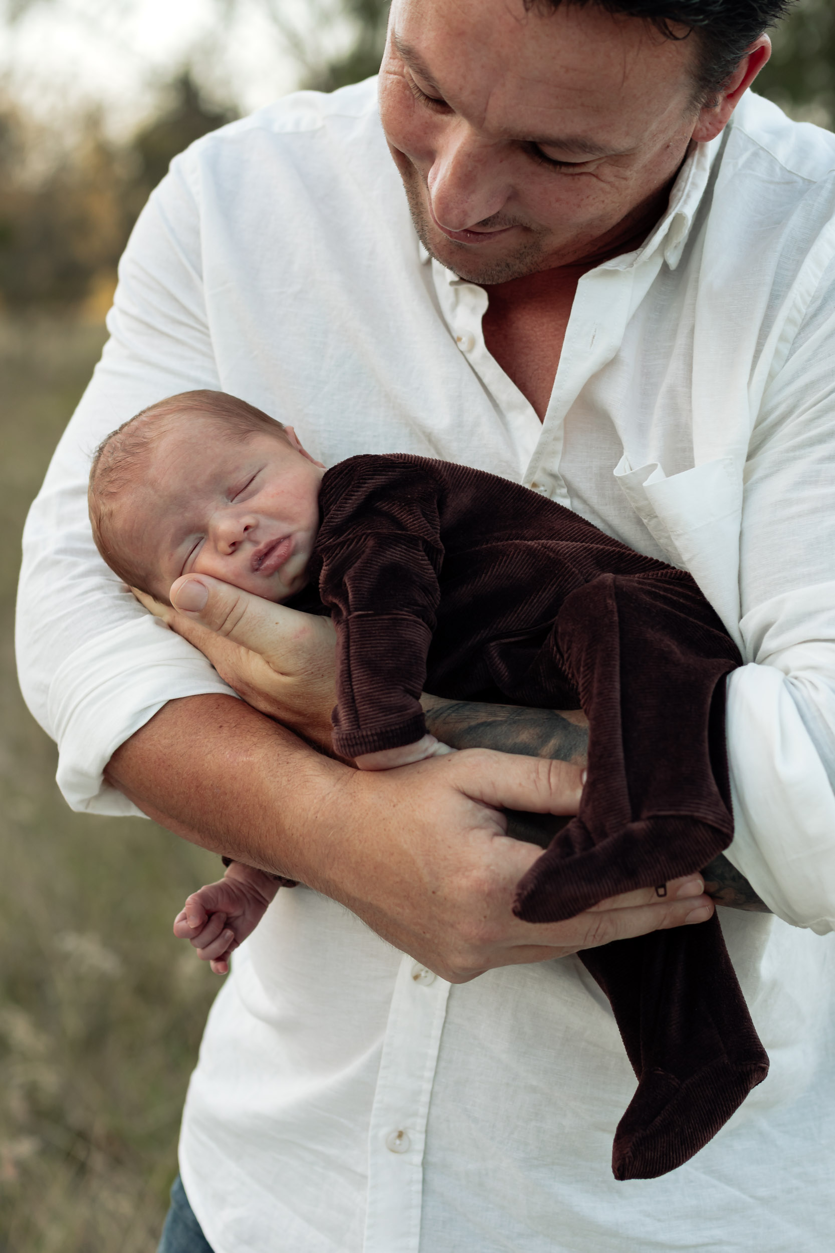 Father holding baby on his arm in a cuddle