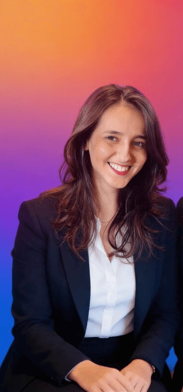 Portrait of a laughing person with curly hair wearing a white shirt