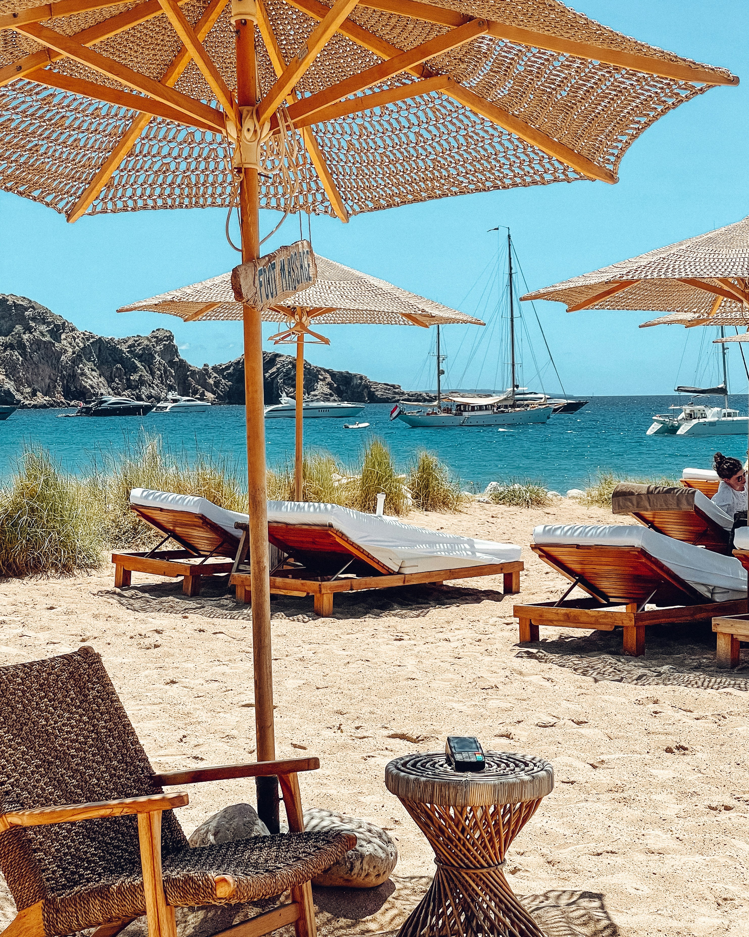 brown wooden beach lounge chairs on beach during daytime