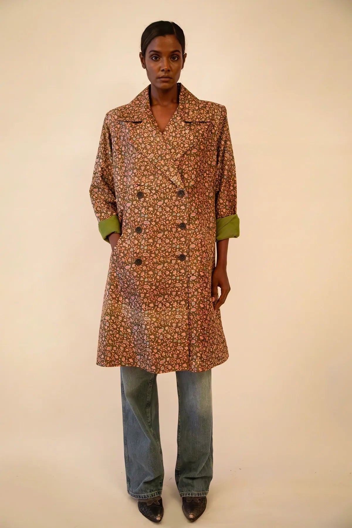 Ved is our one-of-a-kind paisley olive green silk trench coat, handcrafted by skilled artisans in-house using a vintage silk sari