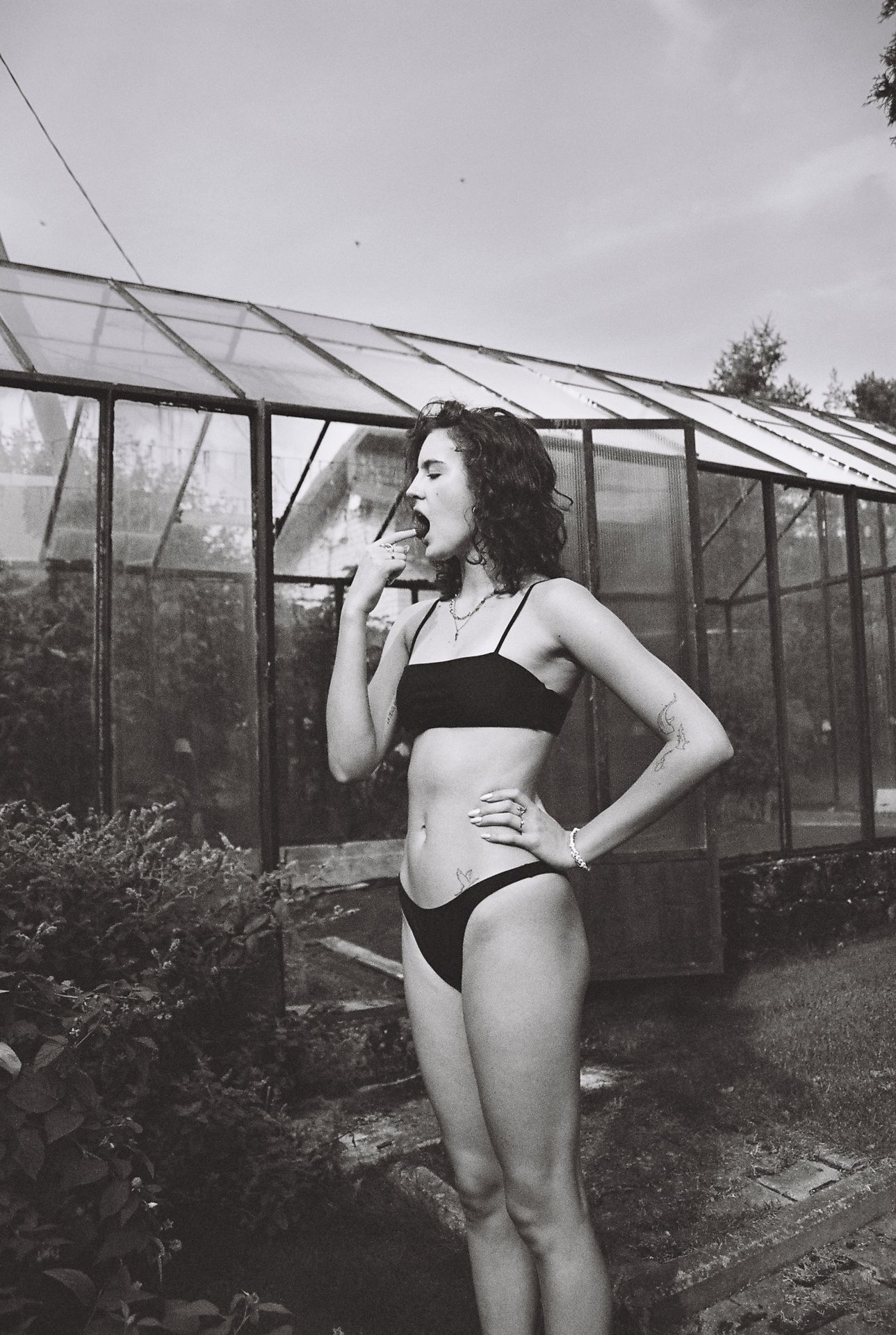 woman standing next to a garden