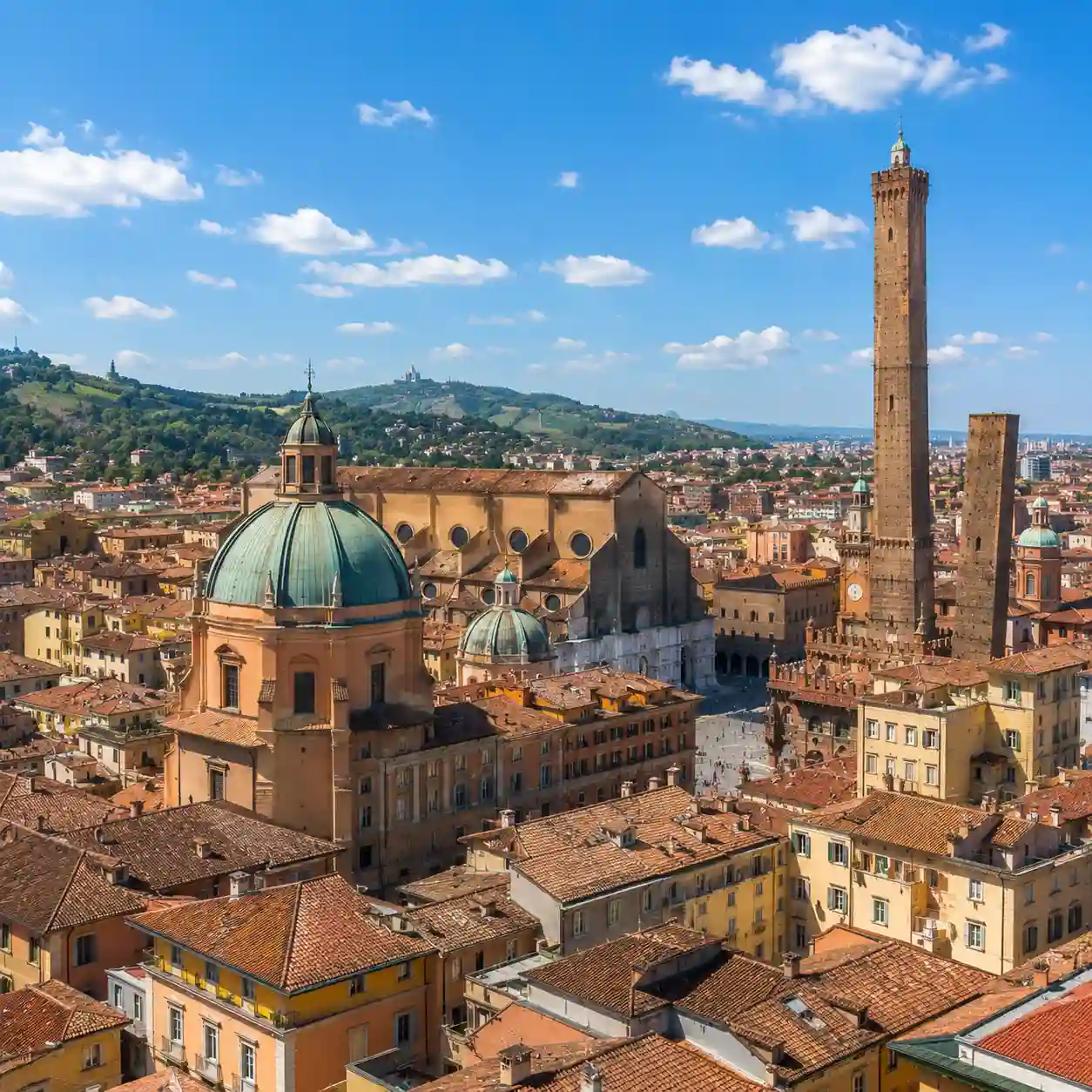 Sunny skyline of Bologna, Italy, featuring the city's historic towers and representing student accommodation options for international students