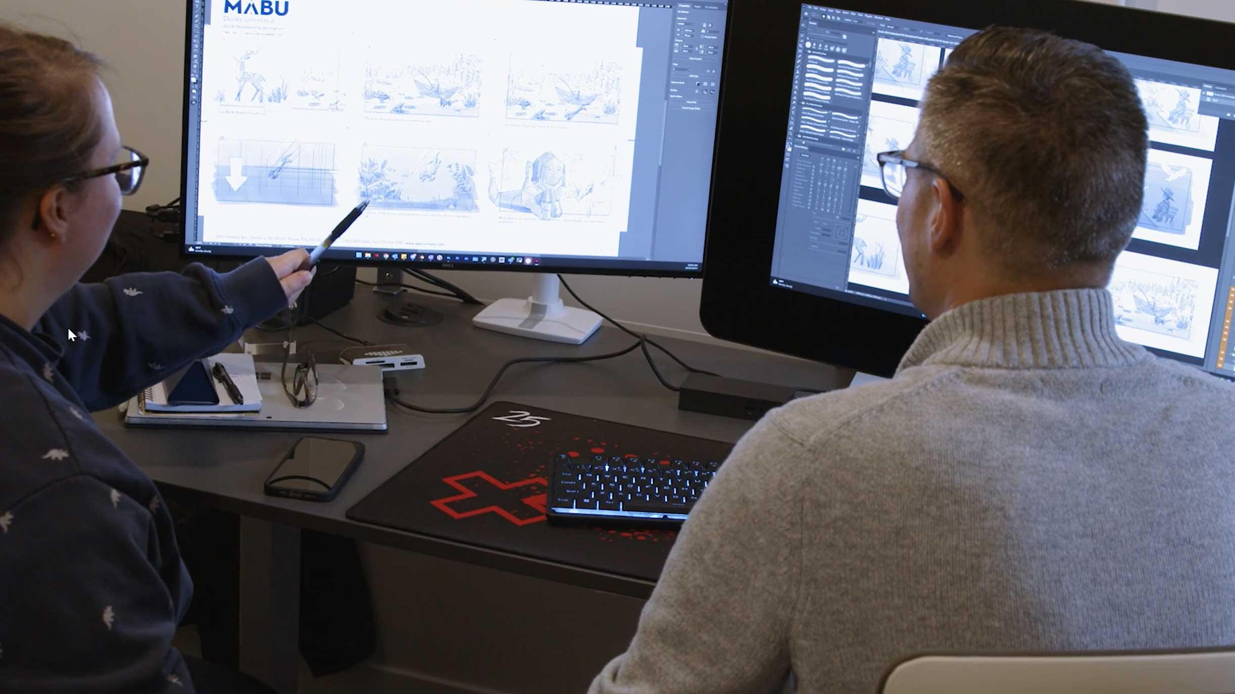 Ed and Molly looking at storyboard