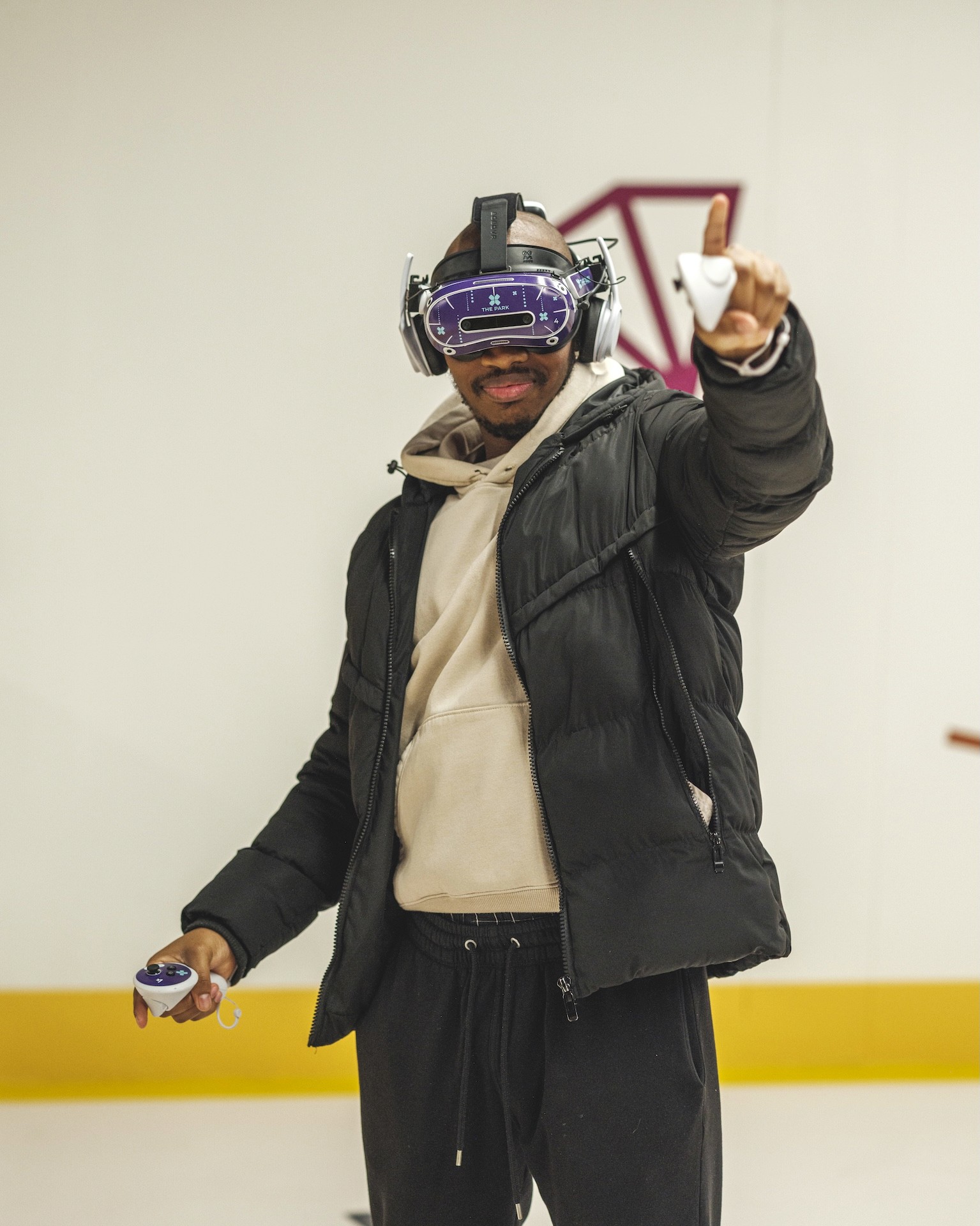 A person wearing a VR headset and holding a controller, getting mission-ready with the latest VR technology at The Park.