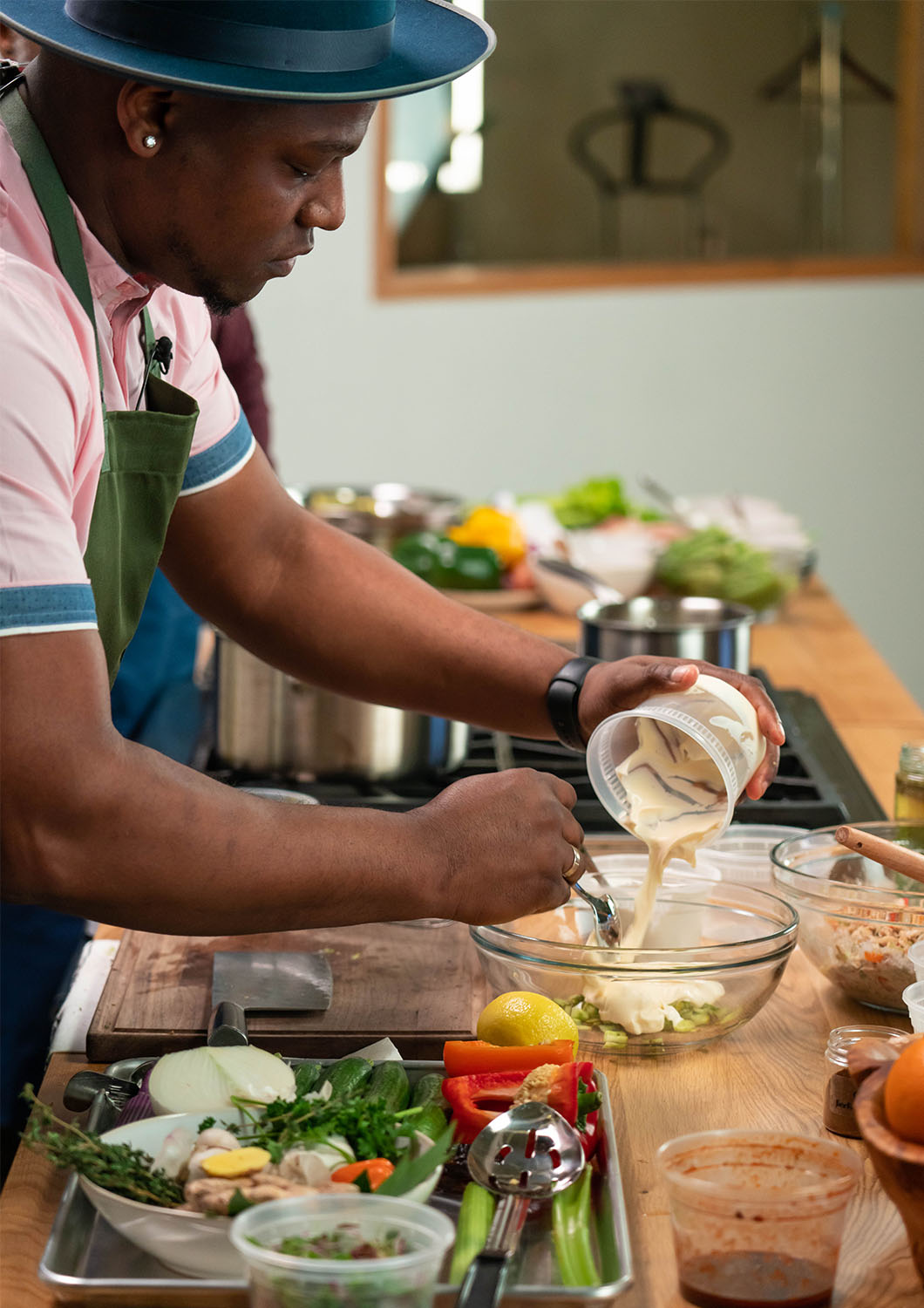 Chef Tre Lamont prepares a dish on the countertop of the studio kitchen at Particle Studio in Seattle Wa