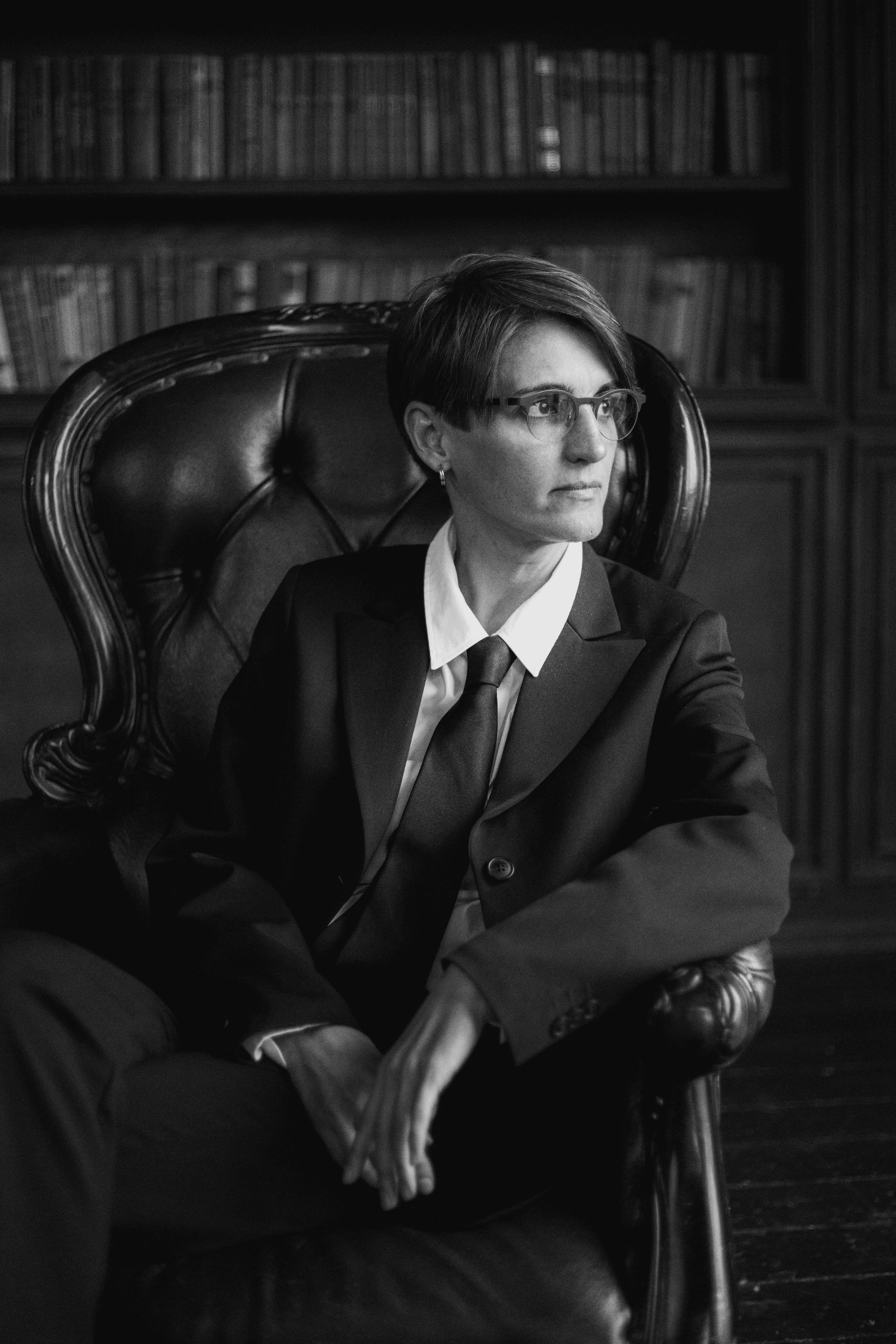 Photo by KATRIN  BOLOVTSOVA: https://www.pexels.com/photo/grayscale-photo-of-a-female-lawyer-sitting-on-a-chair-6077440/