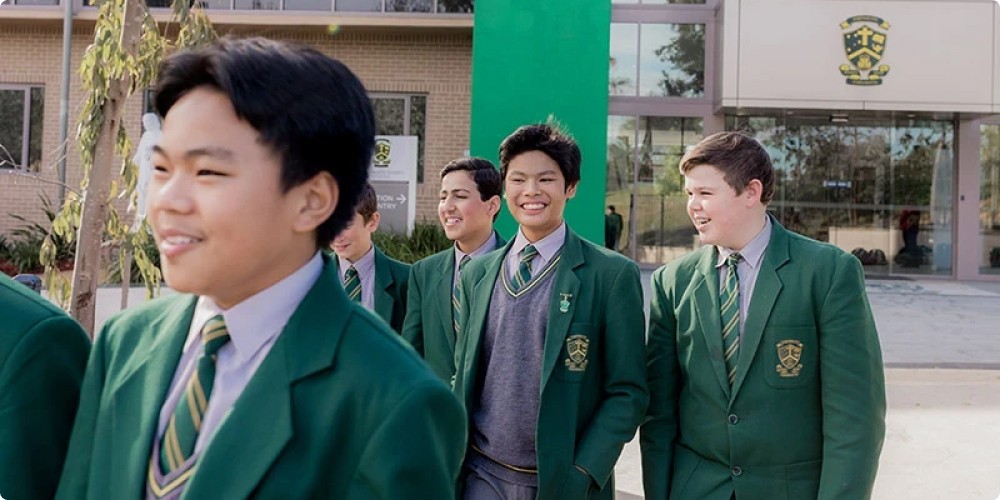 a group of children in green school uniforms