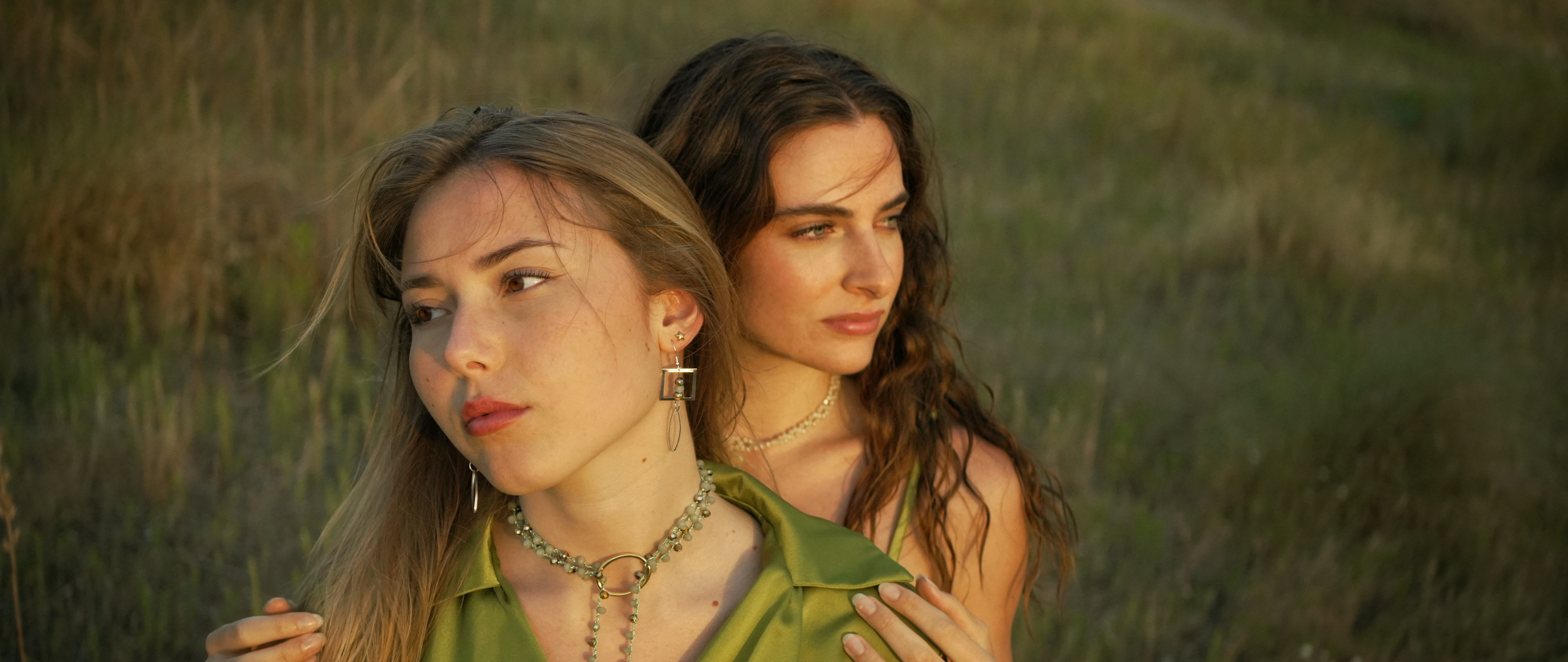 Tree branches reach towards a clear, blue sky.