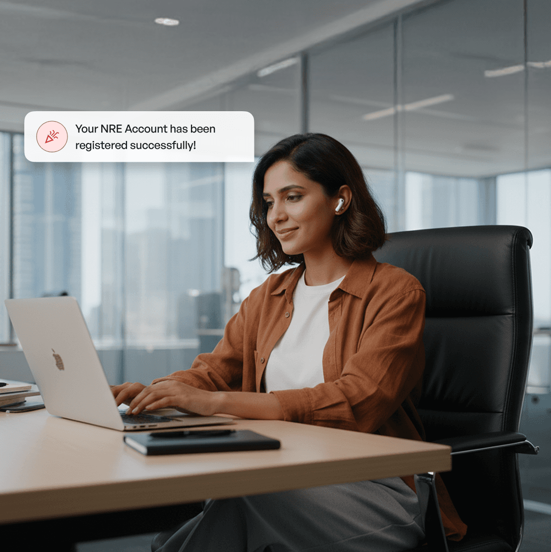 Man smiling at his laptop after receiving a 'HUF Account registered' notification.