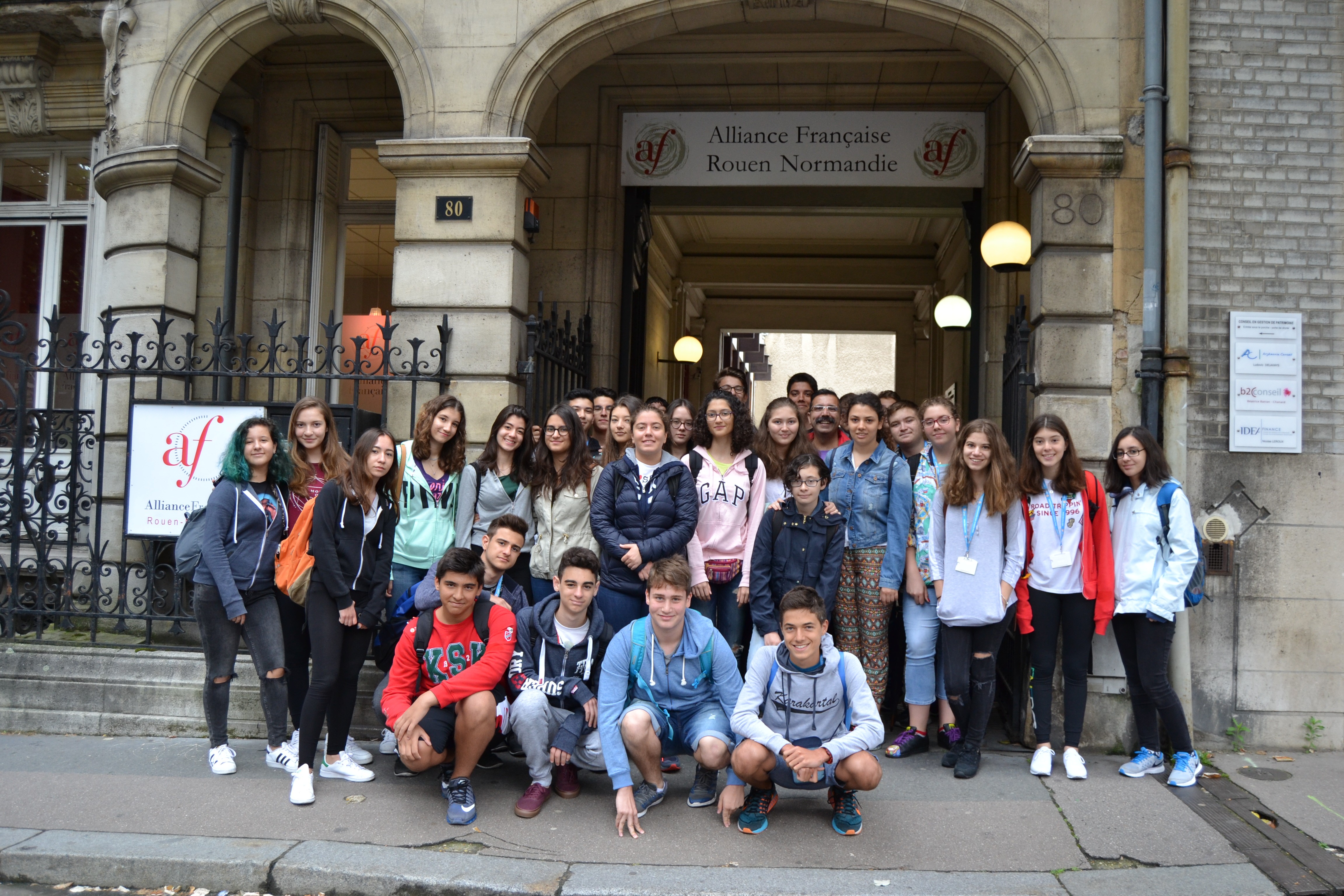 Blue rally car kicking up dust on dirt road