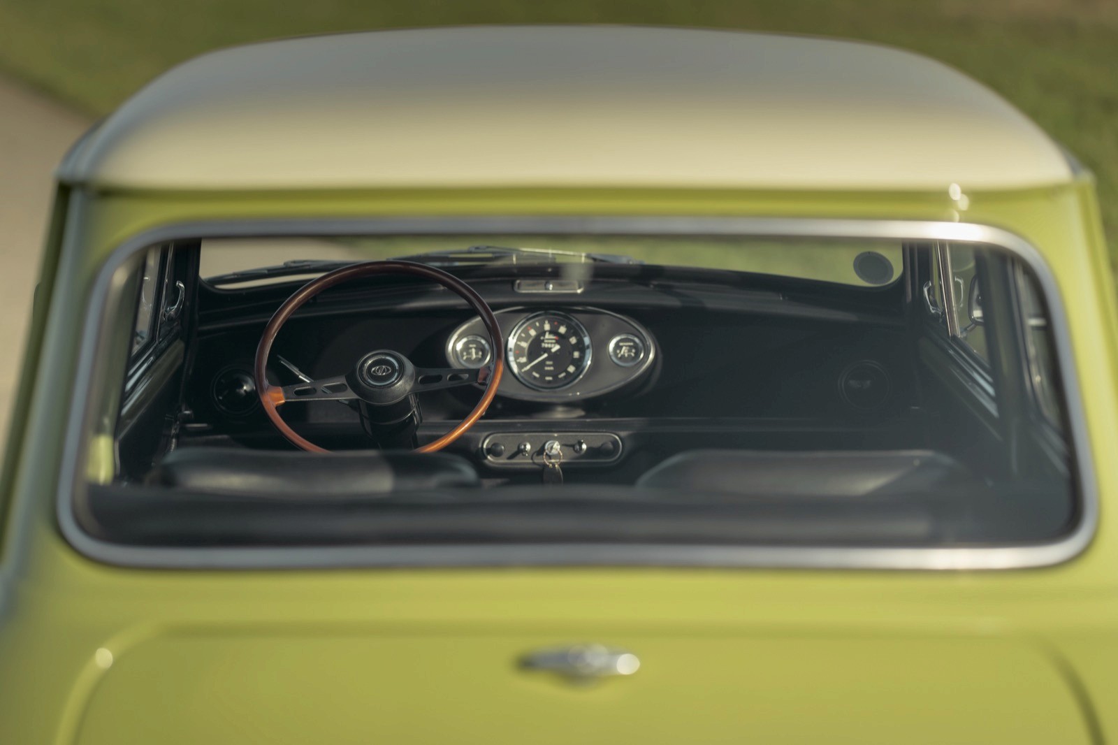 A close-up view of a classic car's dashboard, showcasing vintage controls and a steering wheel.